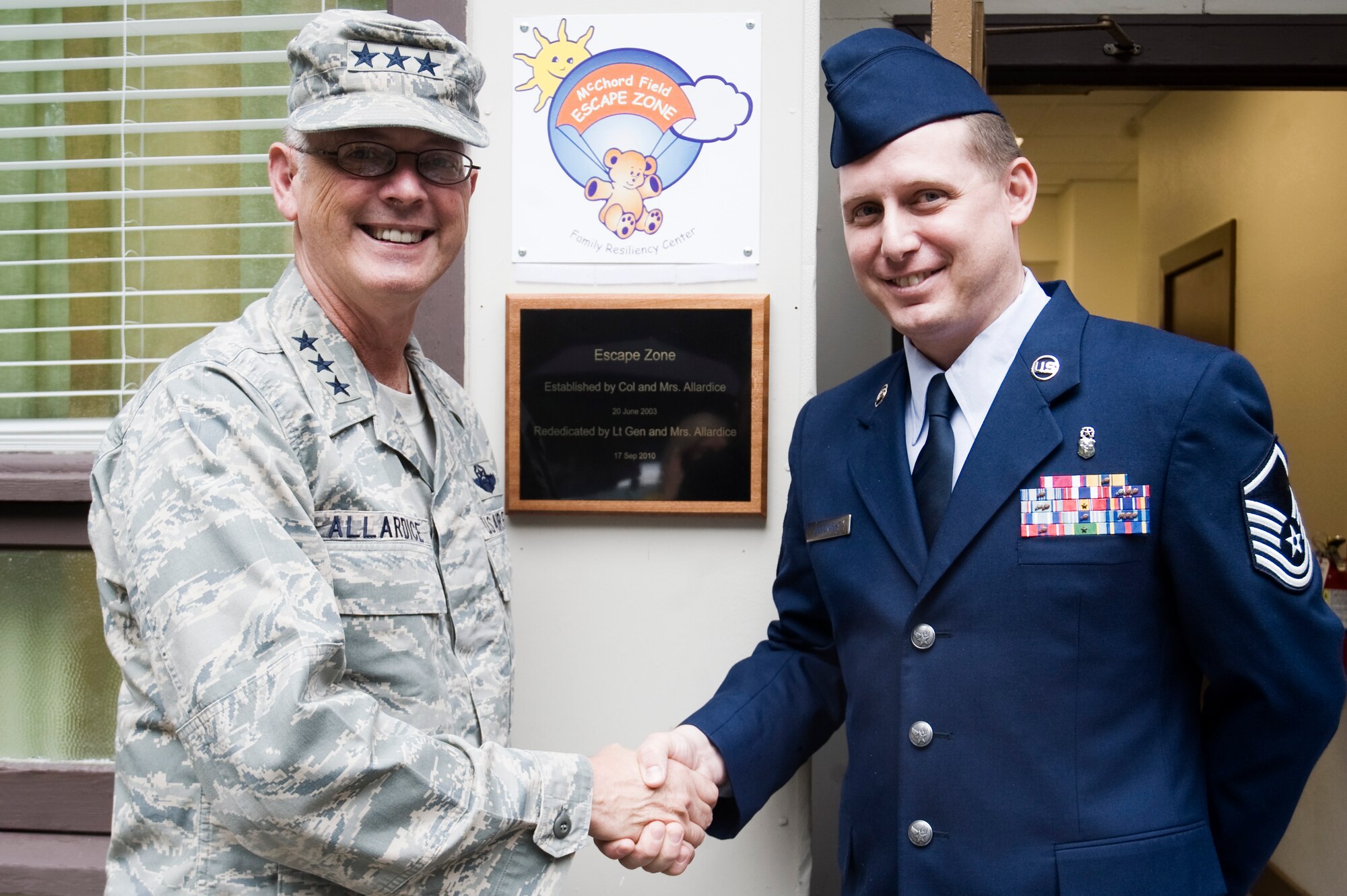 Lt. Gen. Robert R. Allardice, left, 18th Air Force Commander, and Master Sgt. Andrew Goodnight, 62nd Force Support Squadron NCOIC of the Airmen & Family Readiness Center, pause for a photo at the re opening of the Escape Zone Sept. 17 at Joint Base Lewis-McChord, Wash. The plaque, displayed next to the front entrance of the Escape Zone, reads "Established by Col. and Mrs. Allardice, 20 June 2003. Re dedicated by Lt. Gen. and Mrs. Allardice, 17 Sep 2010". (U.S. Air Force Photo/Abner Guzman)