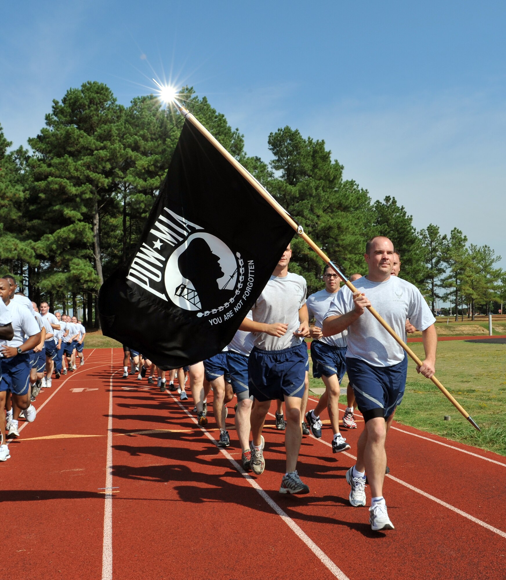 Members of the 19th Equipment Maintenance Squadron run on the base War Fit Track holding the Prisoner of War Missing in Action flag during their hour block Sept. 17.  Several squadrons from across the base participated in a 24 hour run in memory of the nation’s POW and MIA veterans.  (U.S. Air Force photo by Staff Sgt. Chris Willis)