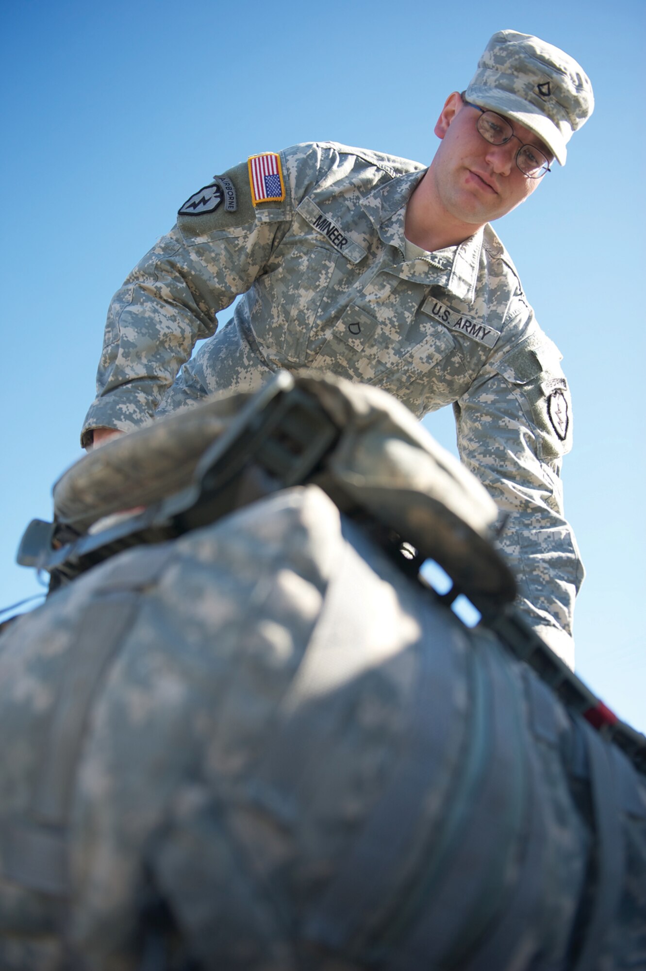 Spc. Adam Mineer, A/425th BSTB, weighs his rucksack to ensure it conforms to the 35-pound minimum. (Photo by David Bedard/JBER PAO)