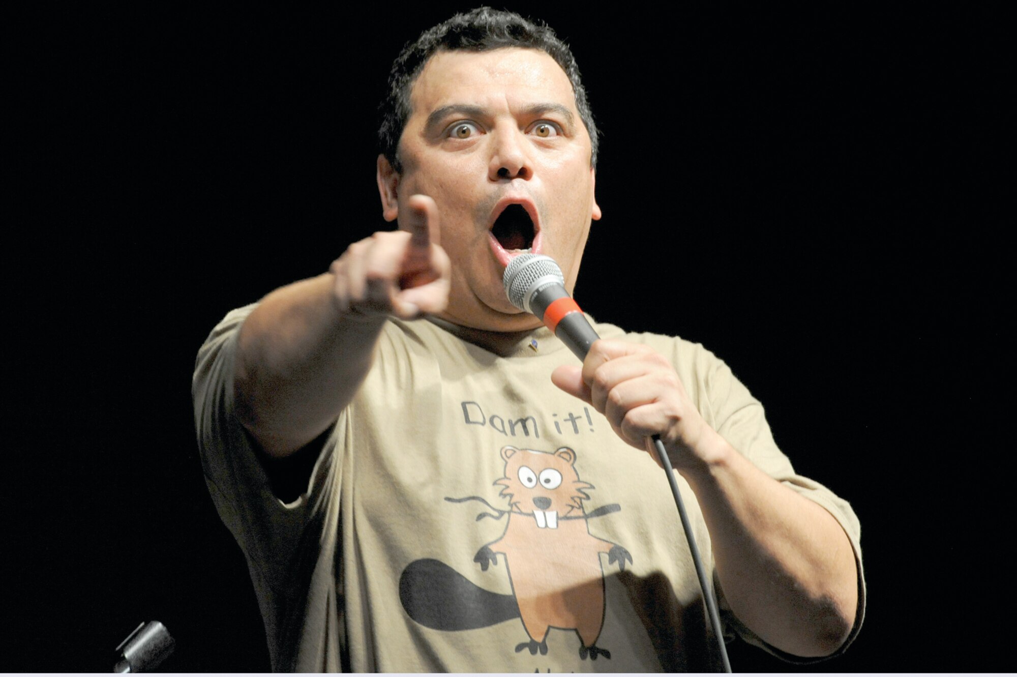 Comedian Carlos Mencia, points at crowd members while telling a joke during
his stand-up comedy act at the Dena’ina Convention Center, Sept. 10. (Photo by Air Force Staff Sgt. Joshua Garcia/JBER PAO)