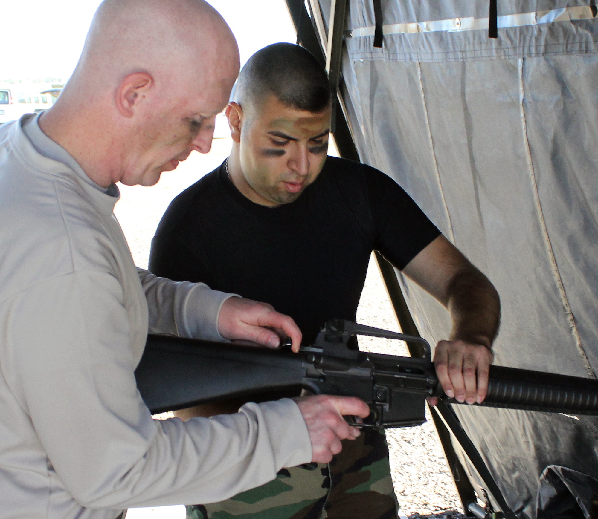 Tech. Sgt. David Bader and Staff Sgt. Roger Hernandez take apart an M-16 during the Warrior Challenge on Sept. 10. Nearly 100 Airmen participated in the competition which featured 13 stations of physical and team-building challenges. (U.S. Air Force photo by Senior Master Sgt. Tom Kimball)