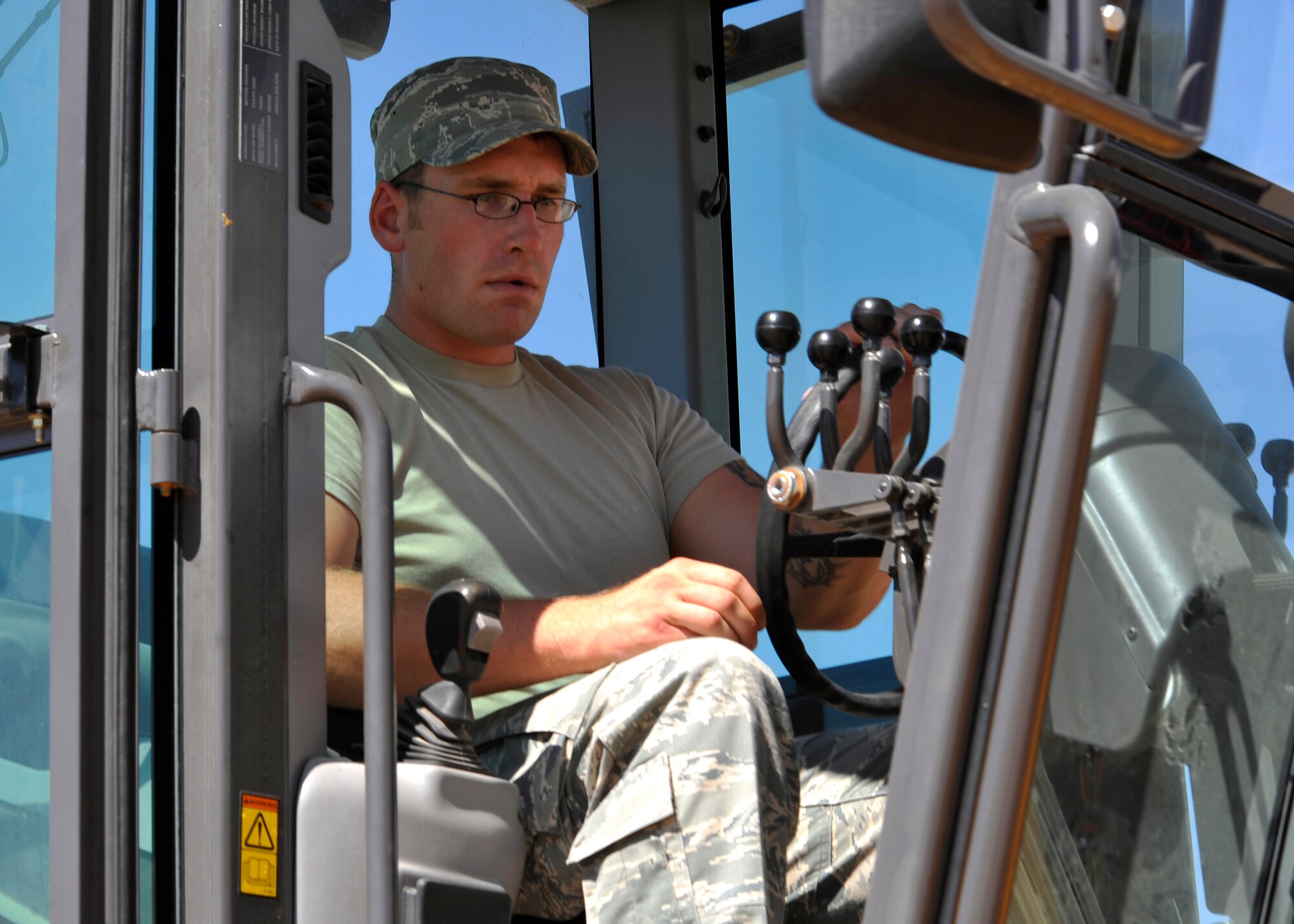 HOLLOMAN AIR FORCE BASE, N.M. -- Airman 1st Class Matthew Carpenter, 49th Civil Engineer Squadron, operates a motor grader, Sept. 15, 2010, through the dirt of what will be an extension to the parking lot at the Domenici Fitness and Sports Center. Although it was Airman Carpenter's first day working at the construction site, it won't take long before the "Dirt Boyz" are able to make room for Airmen to park their cars on a cemented lot for early morning physical training. (U.S. Air Force photo by Senior Airman Veronica Stamps / Released)