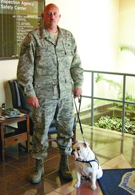 Master Sgt. Justin Jordan takes a break with his 2-year-old English Bulldog, Dallas. Dallas is a service dog trained to help Sergeant Jordan recover from post-traumatic stress disorder. (Courtesy photo)