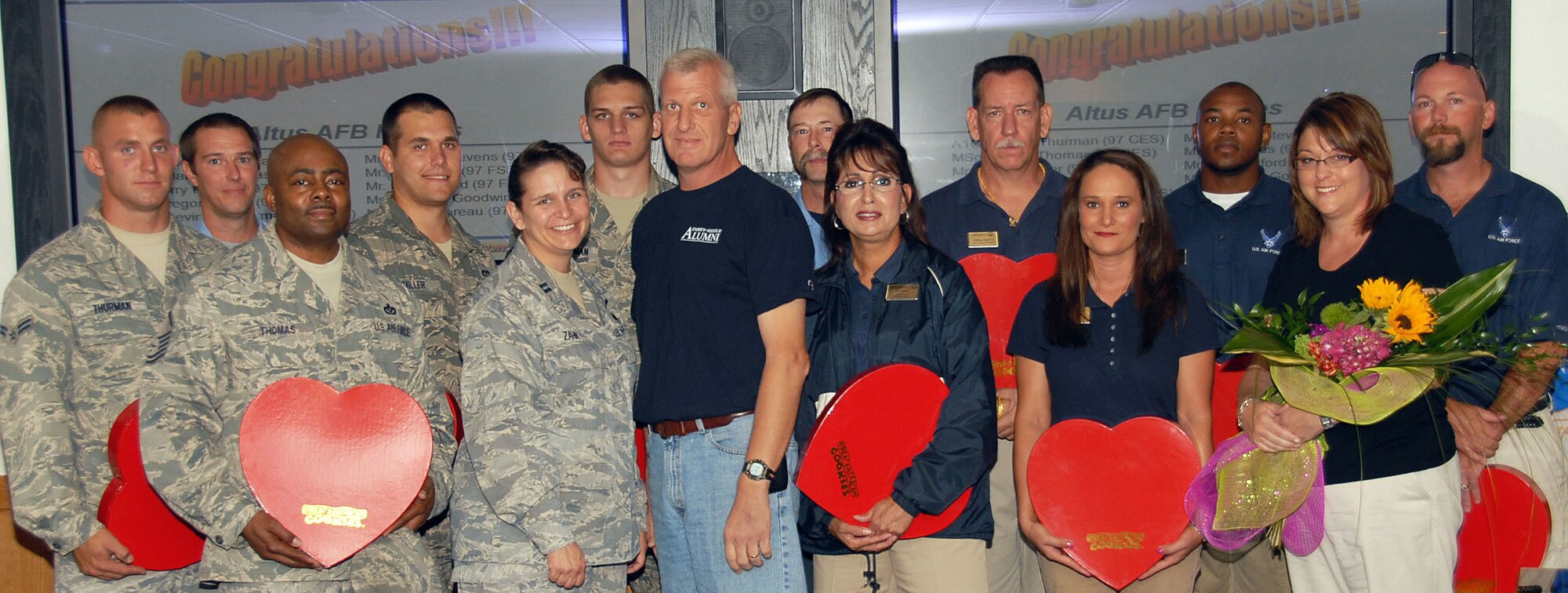 Chief Master Sgt. Bruce Zahn, center, recognizes the Airmen, EMS and fitness staff who came to his assistance after he suffered a heart attack at the Altus Fitness Center Aug. 31, 2010. Chief Zahn presented cookies to those who assisted him Aug. 9. Wing Commander Col. Ty Thomas also presented commander's challenge coins to the honorees. (U.S. Air Force photo/Airman 1st Class Christopher Arnold)