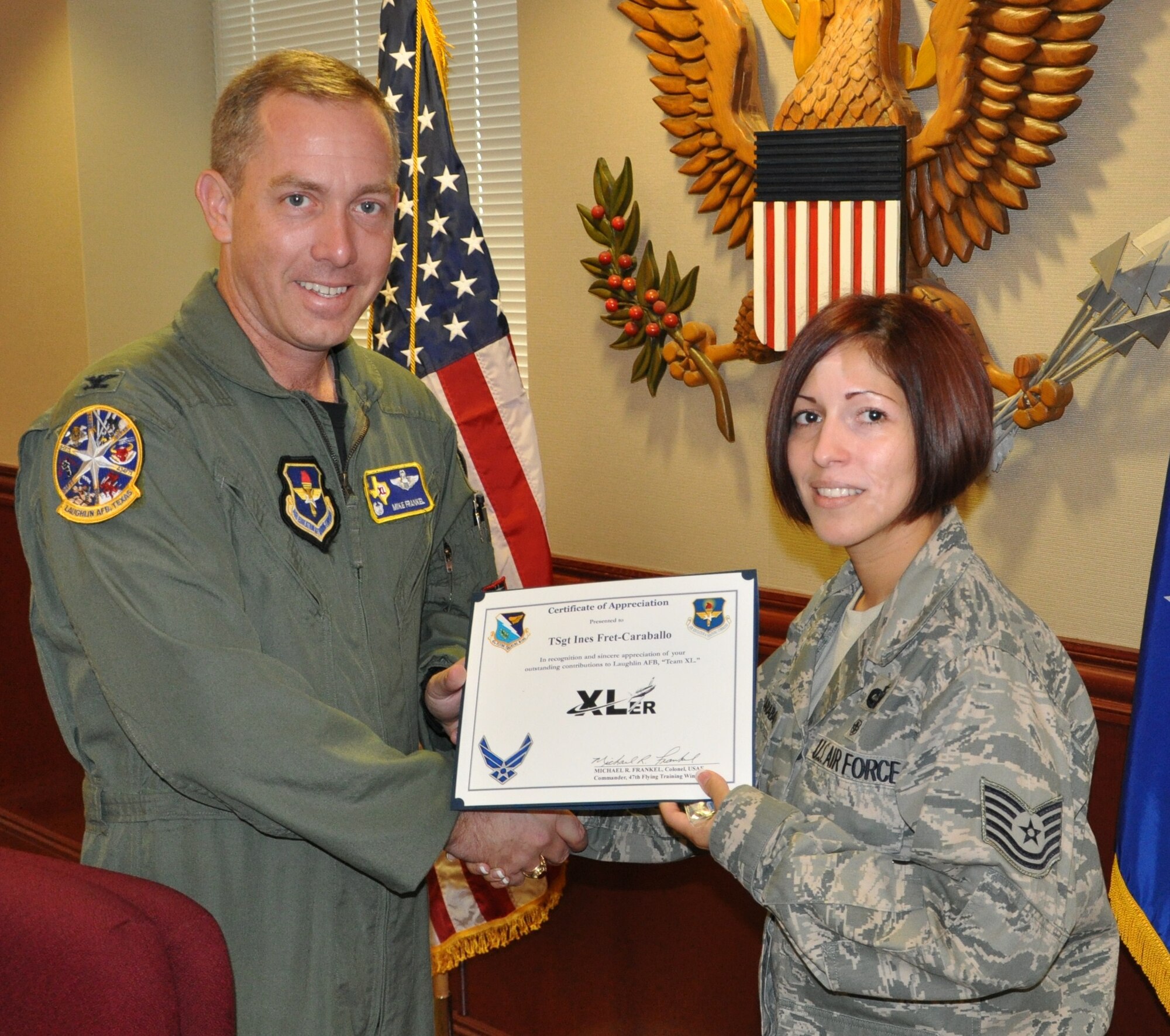 LAUGHLIN AIR FORCE BASE, Texas – Tech. Sgt. Ines Fret-Caraballo, 47th Flying Training Wing Legal Office, is presented the XLer of the Week award by Col. Michael Frankel, 47th FTW commander, Sept. 14. The XLer is a weekly award chosen by 47th FTW leadership and given to individuals who consistently make outstanding contributions to Laughlin and their unit. (U.S. Air Force photo by Airman 1st Class Blake Mize)