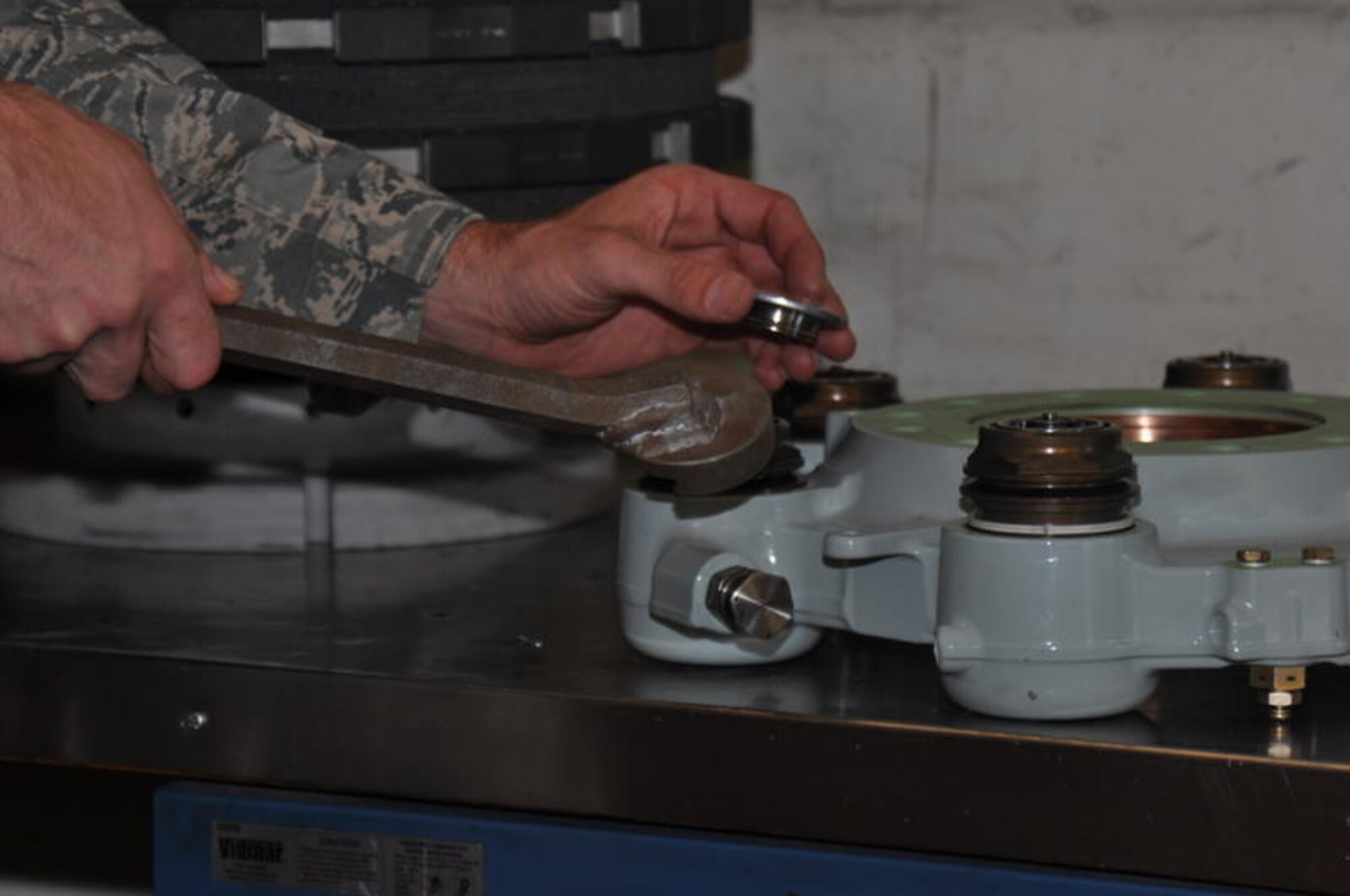 Tech. Sgt. Matthew Stechelin, 60th Maintenance Squadron hydraulic systems shop supervisor, uses the tool he invented to remove an insulator cap from the brake of a C-17 Globemaster III on Sept. 7. The tool is approved for use and is in the final stages of being approved Air Force wide.