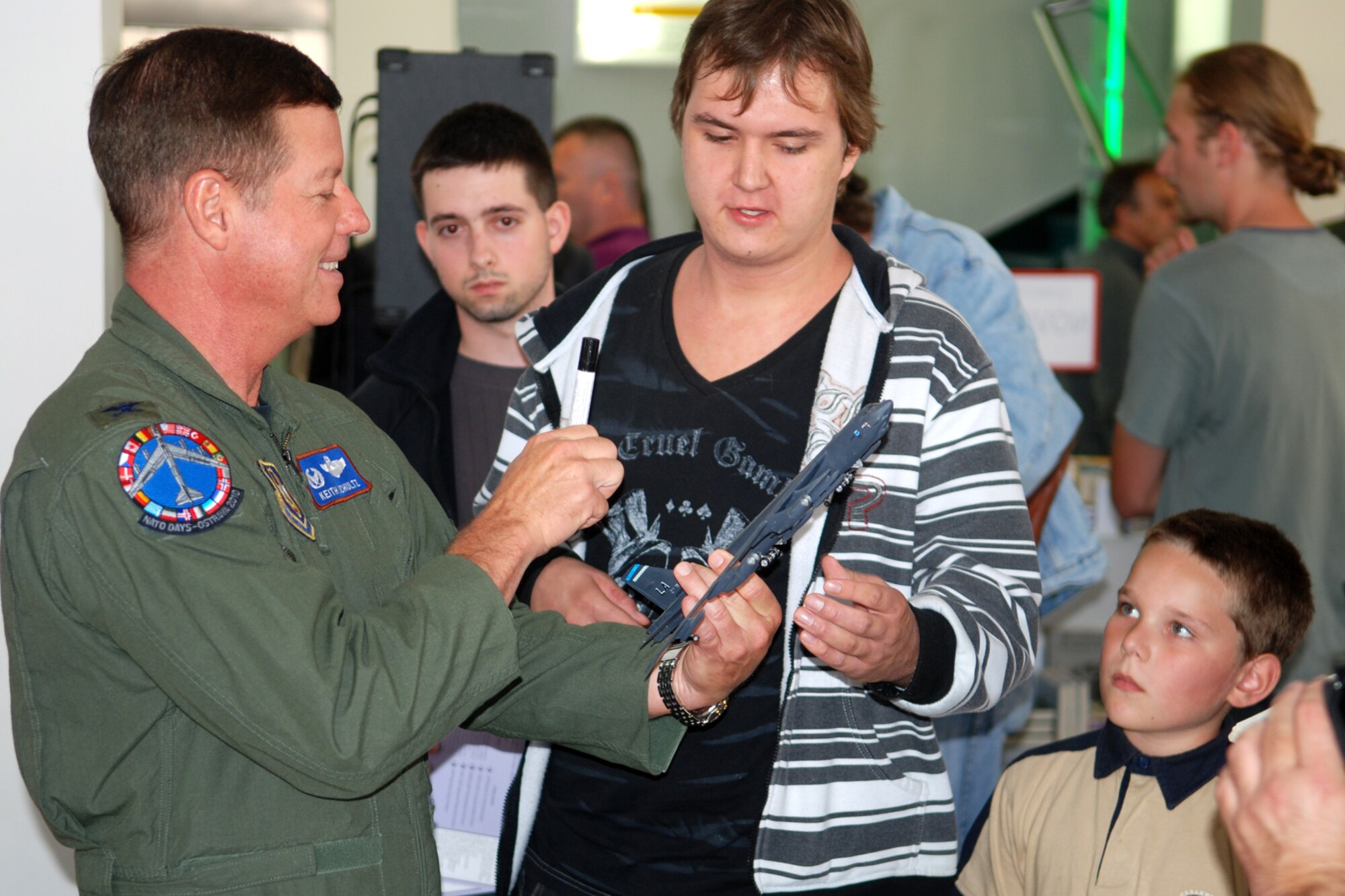 Col. Keith Schultz, 917th Operations Group commander, signs a model of a B-52 Stratofortress for a young man during interviews at a bookstore in Ostrava, Czech Republic, Sept. 17, 2010. Colonel Schultz was part of an historic flight to the Czech Republic in a 93rd Bomb Squadron B-52H Stratofortress in support of the 10th NATO Days in Ostrava & 1st Czech Air Force Days Air Show, which is scheduled for Sept 18-19, 2010, at the Leos Janacek Ostrava Airport, Ostrava, Czech Republic. The 93rd BS is assigned to the 917th Wing at Barksdale Air Force Base, La. (U.S. Air Force photo/Master Sgt. Greg Steele)

