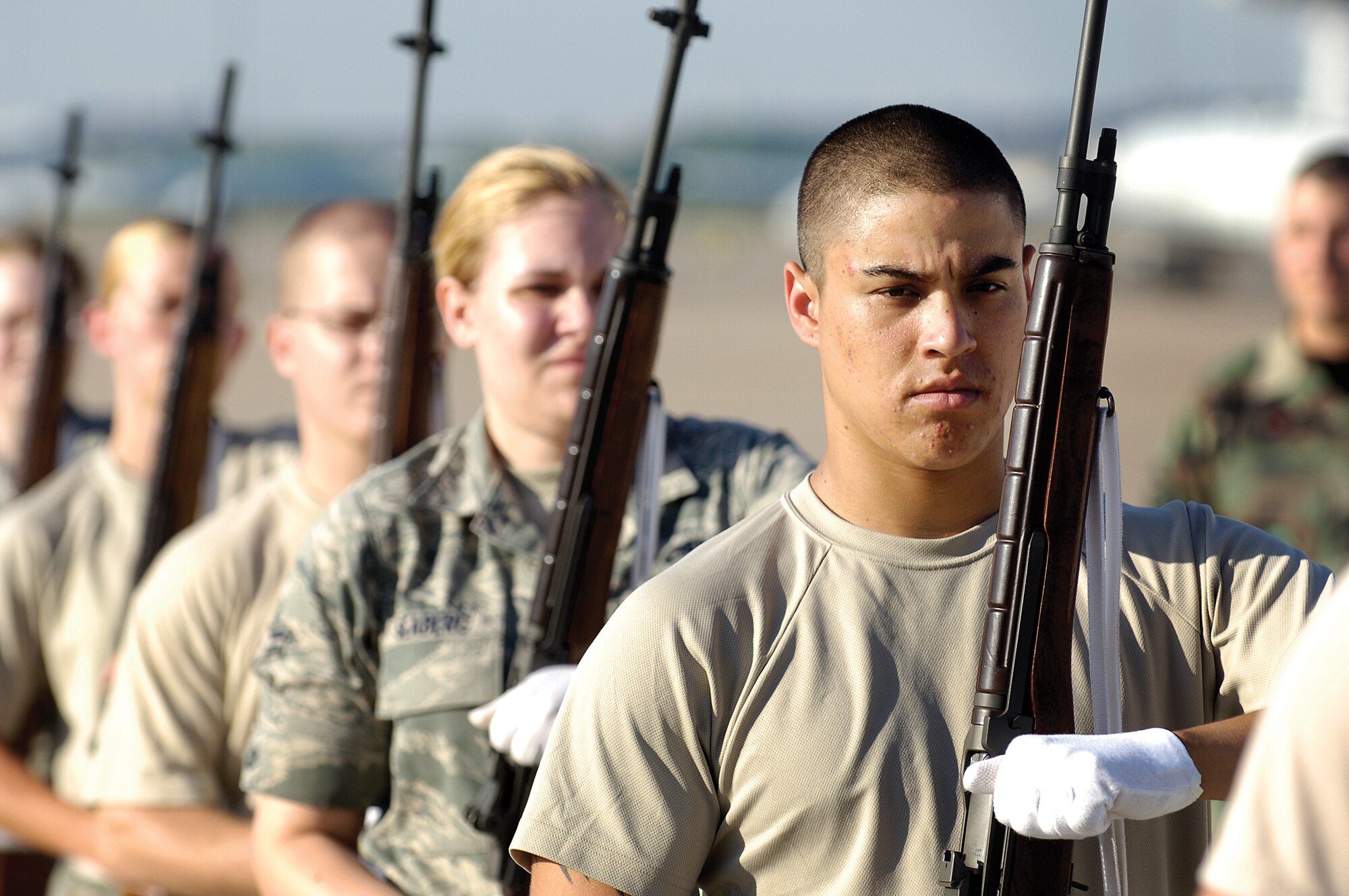 Tinker Honor Guard lead trainer Staff Sgt. Lawrence Bach scrutinizes every movement of trainees during a two-week session where Airmen learn to render honors at funerals and how to present the colors.   “It’s a lot to learn in a short time,” Sergeant Bach said. “Rifling is the hardest movement to learn. And they learn to maintain their bearing under extreme circumstances, four-feet of snow or heat,” he said. (Air Force photo by Margo Wright)