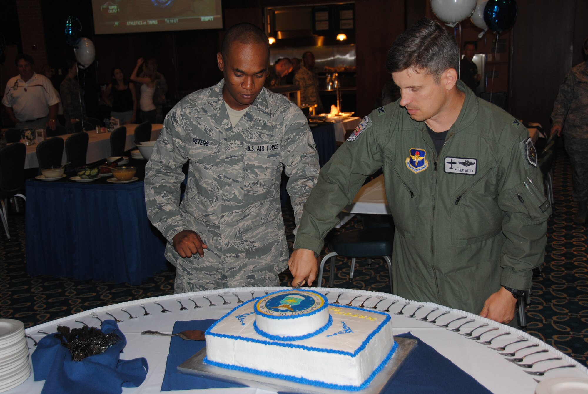 A slice above the rest, Col. Roger Witek, the 71st Flying Training Wing vice commander, and Airman George Peters, a 71st Operations Support Squadron air traffic controller, cut a cake together to commemorate the Air Force's 63rd birthday at the Vance Collocated Club Sept. 17. The two Airmen represent the highest and lowest ranking members on the base.(Air Force photo/Senior Airman Wes Carter) 