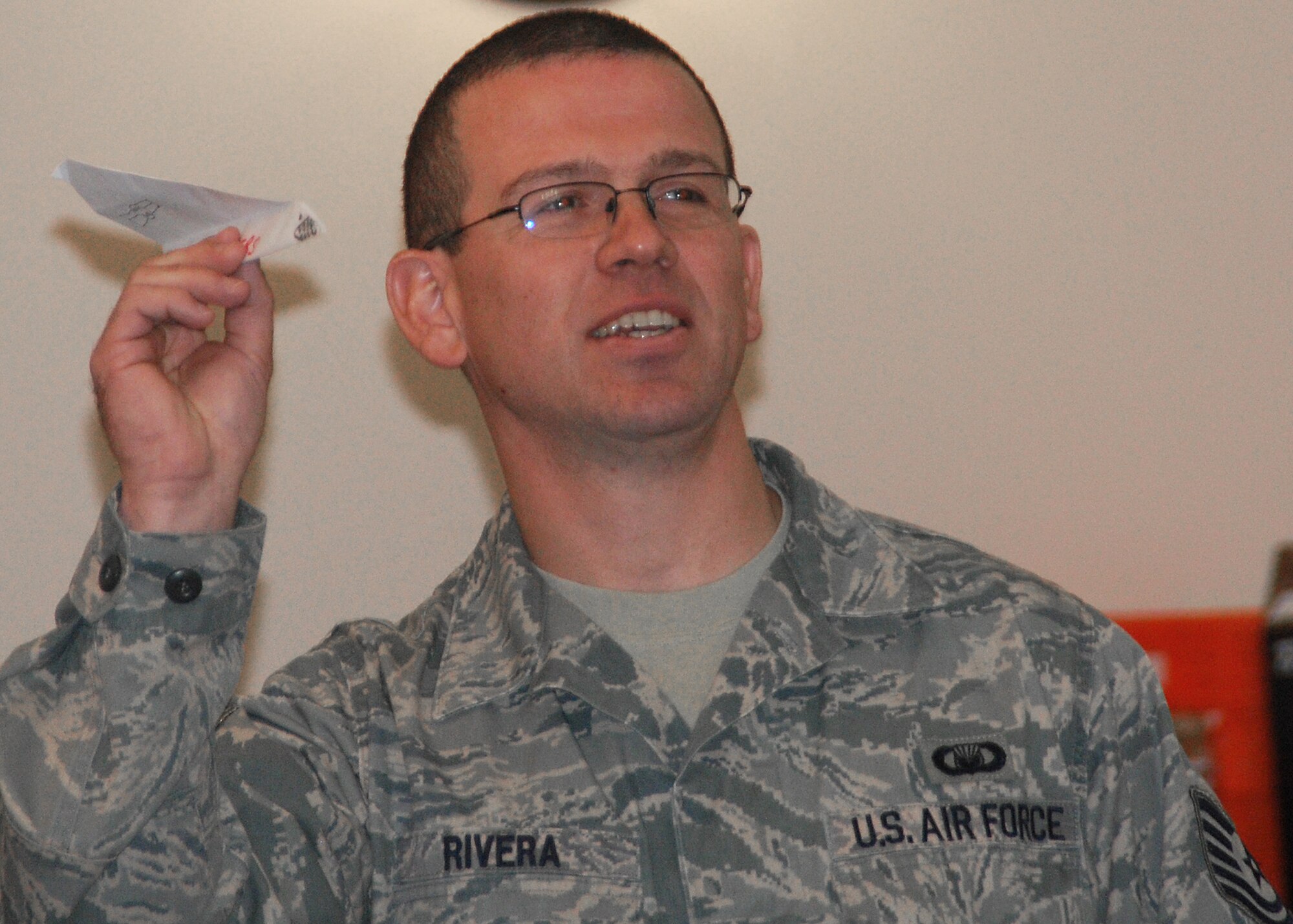 JOINT BASE MCGUIRE-DIX-LAKEHURST, N.J. -- Technical Sgt. Oscar Rivera, 514th Air Mobility Wing chaplain's assistant, prepares to launch a paper airplane as part of a team-building exercise during the Career Enlisted Workshop at the community center here Sept. 14. The exercise allowed Airmen to come together as teams and emphasized nonverbal communication skills. (U.S. Air Force photo/ Airman 1st Class Kerelin Molina)