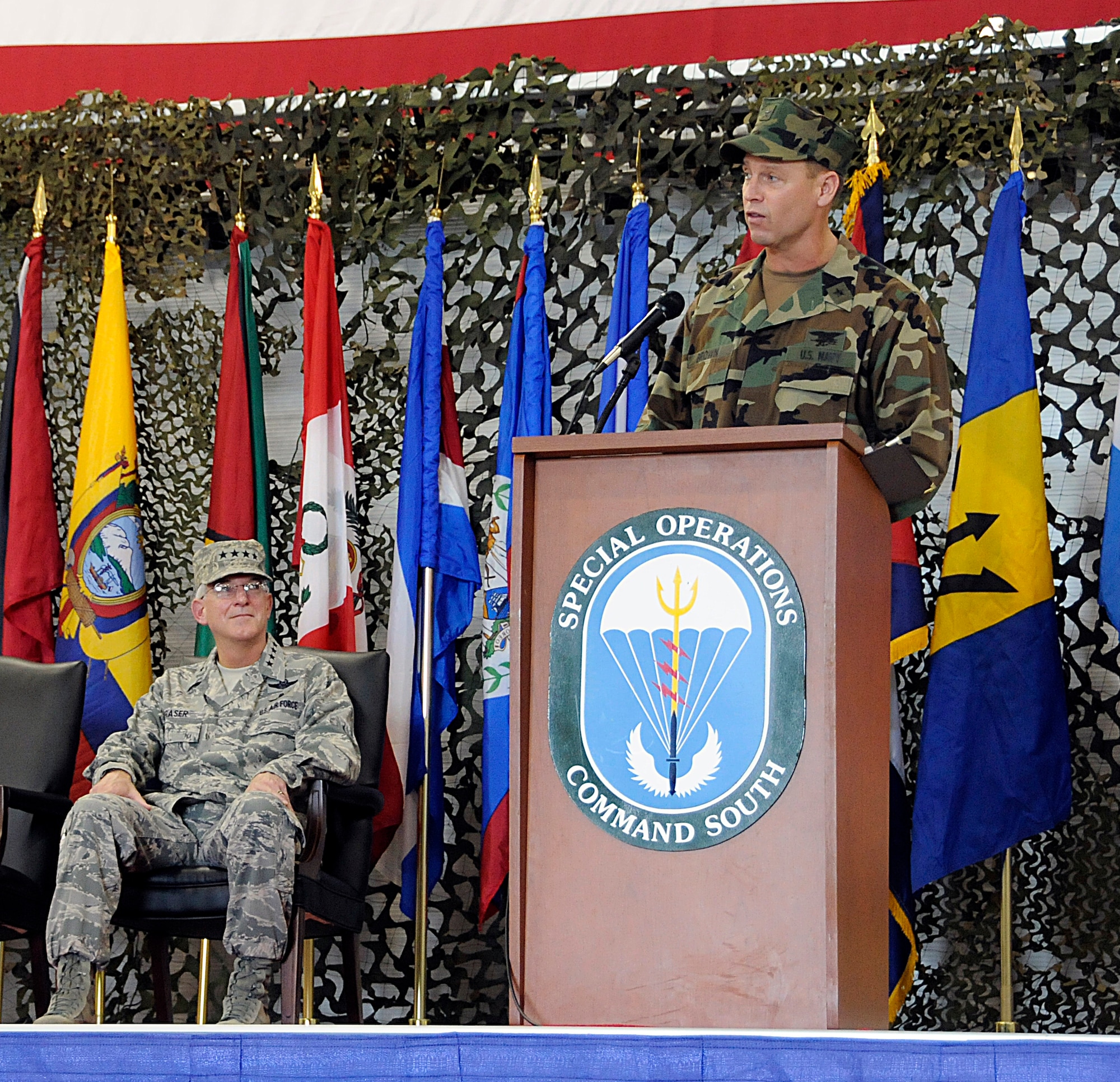 New SOCSOUTH commander, Rear Adm. Thomas L. Brown II addresses the audience while Gen. Douglas Fraser, Commander, U.S. Southern Command looks on during the change of command ceremony at Homestead Air Reserve Base, Fla., on Sep.17.  (U.S. Air Force photo/Tim Norton)