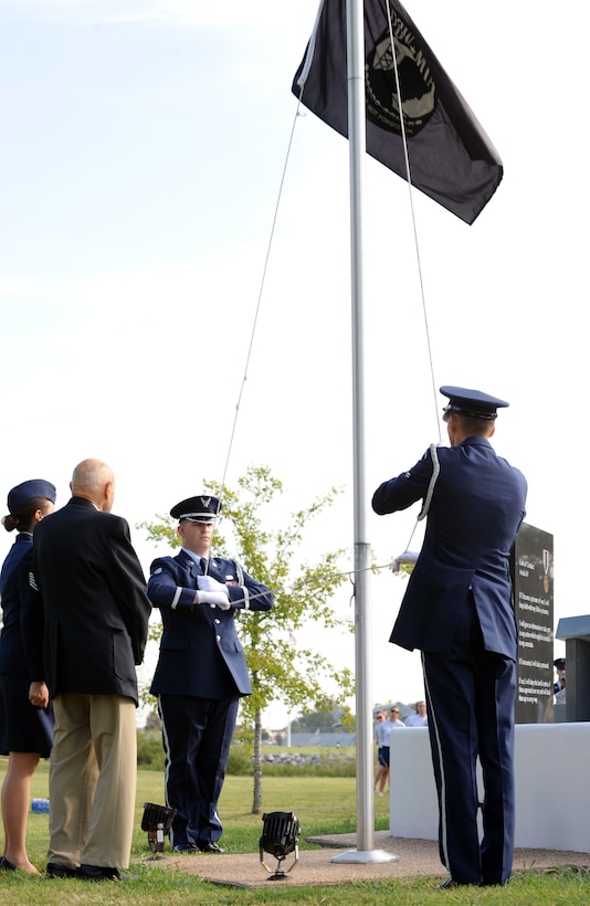 LANGLEY AIR FORCE BASE, Va. – James Ashley, a former prisoner of war, renders a salute with the Base Honor Guard Airmen after raising the flag during the POW/MIA recognition ceremony Sept. 17.  Participants carried the flag around Langley through the night, arriving at the memorial, in time to kick-off the 633d Air Base Wing ceremony honoring our nation’s POWs and missing in action. (U.S. Air Force photo/Staff Sgt. Tabitha Kuykendall) (RELEASED)
