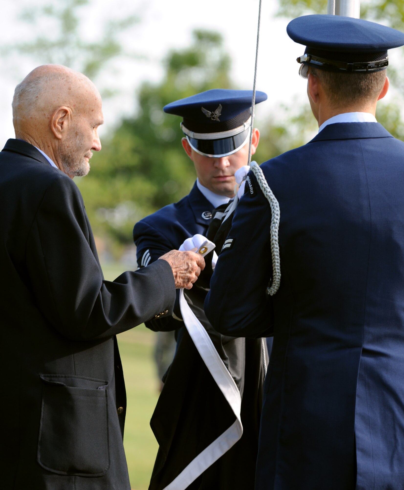 LANGLEY AIR FORCE BASE, Va. – James Ashley, a former prisoner of war, joins the Base Honor Guard Airmen in raising the flag during the POW/MIA recognition ceremony Sept. 17.  Participants carried the flag around Langley through the night, arriving at the memorial, in time to kick-off the 633d Air Base Wing ceremony honoring our nation’s POWs and missing in action. (U.S. Air Force photo/Staff Sgt. Tabitha Kuykendall) (RELEASED)
