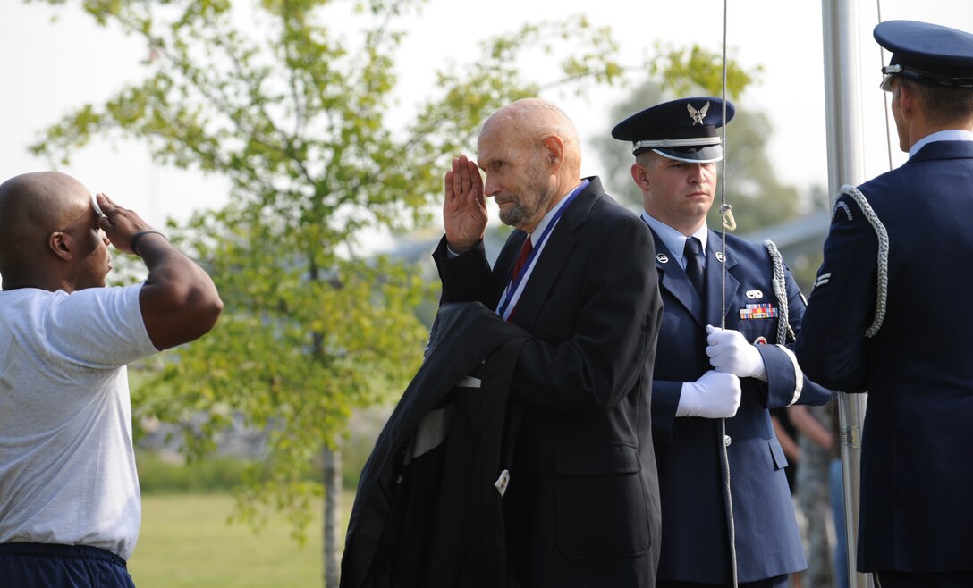 LANGLEY AIR FORCE BASE, Va. – Tech. Sgt. Elroy Williams, Air Combat Command, salutes James Ashley, a former prisoner of war, during the POW/MIA recognition ceremony Sept. 17.  The Base Honor Guard Airmen then joined him in raising the iconic flag to honor honored our nation’s prisoners of war and missing in action.  (U.S. Air Force photo/Staff Sgt. Tabitha Kuykendall) (RELEASED)