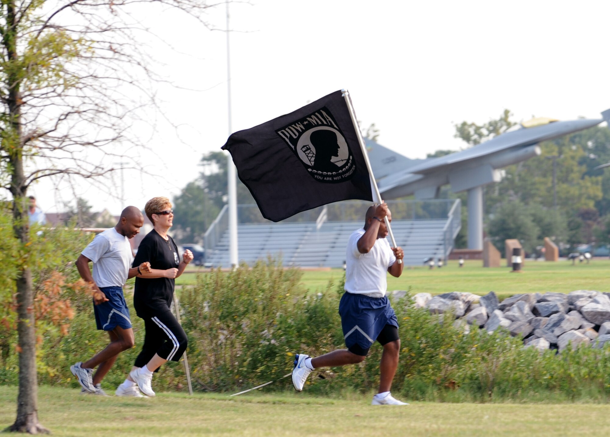 LANGLEY AIR FORCE BASE, Va. – Tech. Sgt. Elroy Williams, Air Combat Command protocol, and participants run the flag to the Prisoners of War/Missing in Action memorial Sept. 17.   The flag was carried around Langley through the night, arriving at the memorial, in time to kick-off the 633d Air Base Wing ceremony honoring honored our nation’s POWs and MIA. (U.S. Air Force photo/Staff Sgt. Tabitha Kuykendall) (RELEASED)