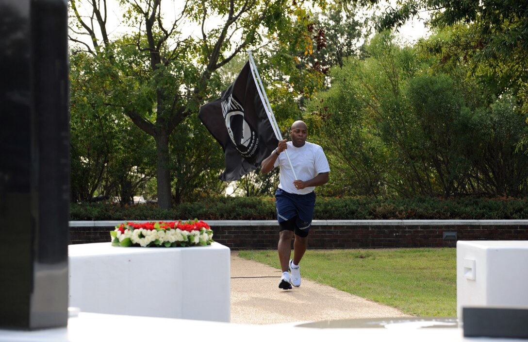 LANGLEY AIR FORCE BASE, Va. – Tech. Sgt. Elroy Williams, Air Combat Command, runs a flag to the Prisoners of War/Missing in Action memorial Sept. 17.  Participants carried the flag around Langley through the night, arriving at the memorial, in time to kick-off the 633d Air Base Wing recognition ceremony honoring our nation’s POWs and those MIA. (U.S. Air Force photo/Staff Sgt. Tabitha Kuykendall) (RELEASED)