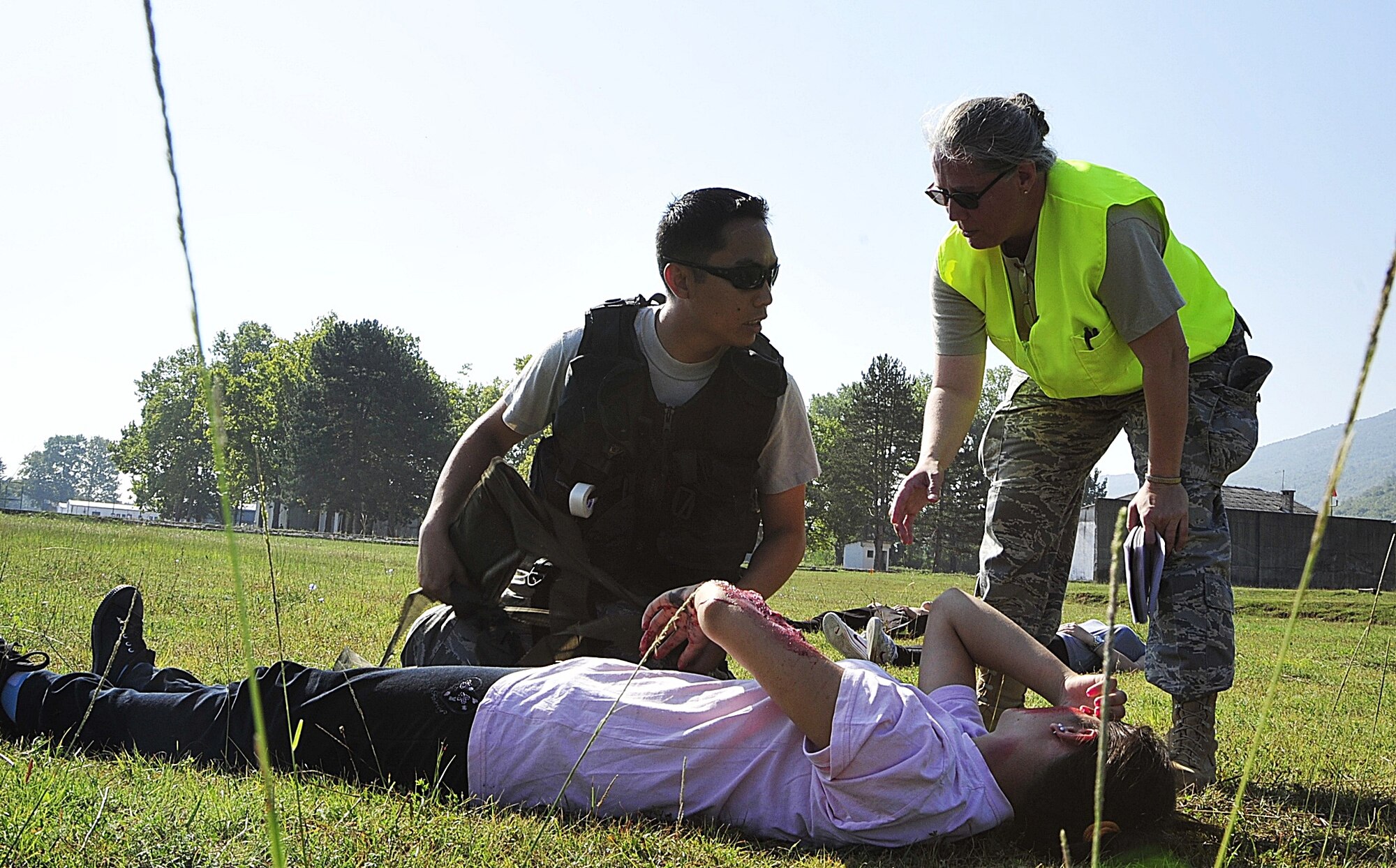 (left to right) United States Air Force Tech. Sgt. Jose Libuano, a medical technician from the 48th Aerospace Medical Squadron at RAF Lakenheath, England, receives guidance from International Expeditionary Education and Training Department USAF School of Aerospace Medicine Chair Col. Nima Reavis from Brooks City-Base, Texas, on the acting victim's situation during a simulated bridge explosion emergency response exercise at Danilovgrad Army Base, Montenegro, Sept. 16. This exercise is a part of MEDCEUR 10, a medical training exercise in central and eastern Europe, in which servicemembers from ten nations are participating in order to receive realistic training to be better prepared for real-world situations. For more information, go to www.usafe.af.mil/medceur.asp and www.odbrana.gov.me. (U.S. Air Force photo/Airman 1st Class Tiffany Deuel)