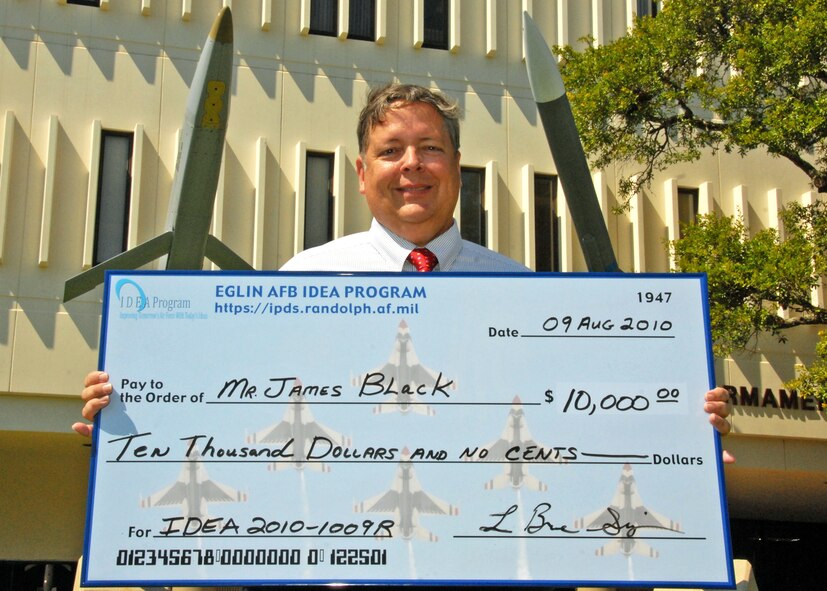 James Black, Air Armament Center, received a $10,000 check Sept. 16 for his idea to salvage bombs with explosive fill irregularities.  He submitted the suggestion through the Innovation Development through Employee Awareness program.  The implemented change will save the Air Force $45 million in the next five years.  (U.S. Air Force photo/Samuel King Jr.)