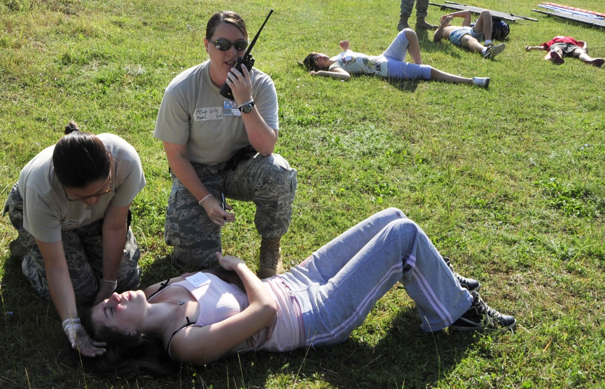(left to right) United States Air Force Master Sgt. Angela Morris, first sergeant for the 48th Munitions Squadron at RAF Lakenheath, England, serves as a medic and helps a victim of a mock bridge explosion as Master Sgt. Sonyia Lilly, family health flight chief of the 48th Medical Operations Squadron at RAF Lakenheath, radios for more medical assistance at Danilovgrad Army Base, Montenegro, Sept. 16. This scenario is a part of MEDCEUR 10, a medical training exercise in central and eastern Europe, in which servicemembers from ten nations are participating in order to receive realistic training to be better prepared for real-world situations. For more information, go to www.usafe.af.mil/medceur.asp and www.odbrana.gov.me. (U.S. Air Force photo/Airman 1st Class Tiffany Deuel)