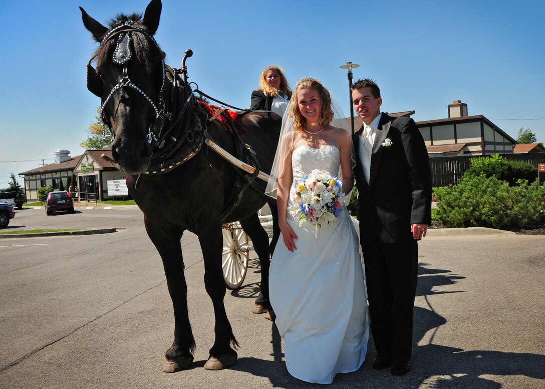 A horse and carriage transport newlyweds Adam and Jessica Wirth around the Niagara Falls Air Reserve Station, August 28, 2010, Niagara Falls NY. Jessica's parents are Senior Master Sgt Desiree Wojcinski, 914th Communication Squadron and retired Master Sgt Michael Wojcinski, 914th Maintenance Squadron. (U.S Air Force photo by Staff Sgt Stephanie Clark)