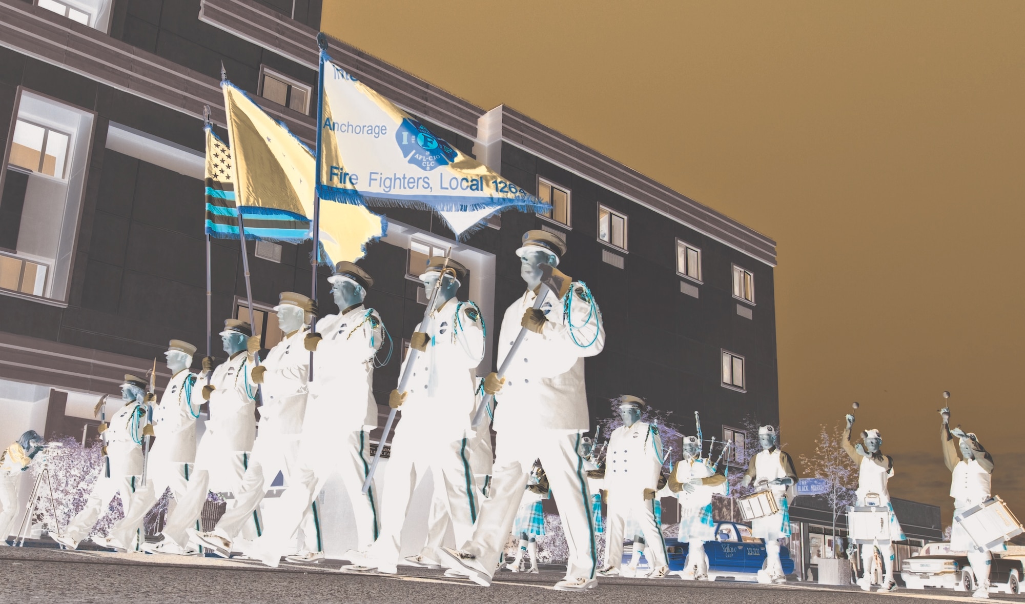 The Anchorage Fire Department Honor Guard and Crow Creek Pipe and Drums players lead a procession along 5th Avenue, Saturday. (Photos by Percy Jones/JBER PAO)