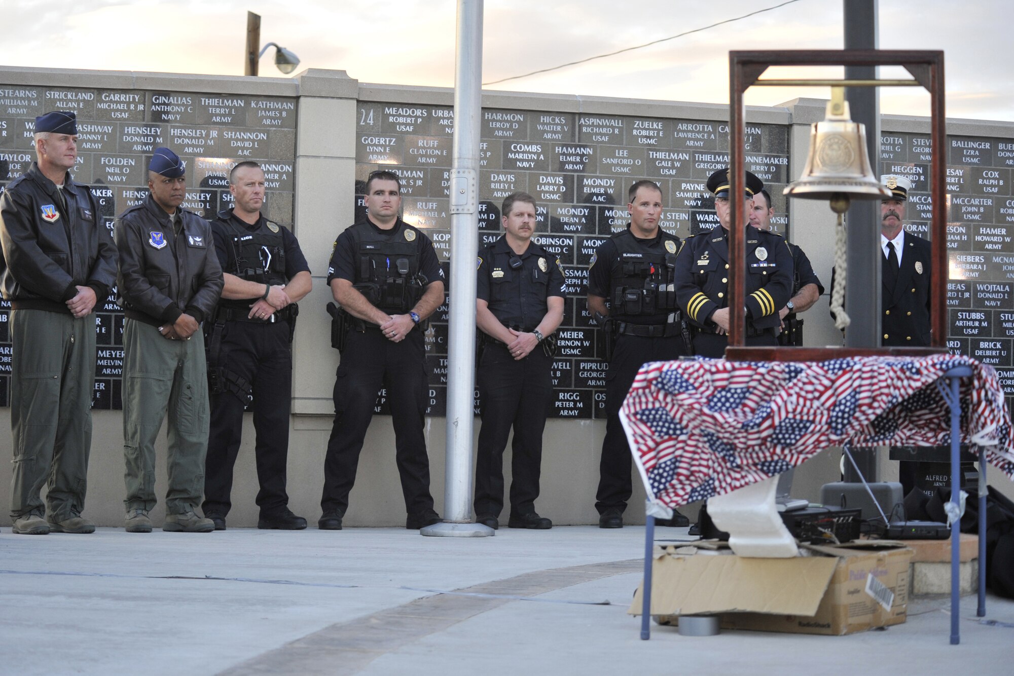 Col. Pete Hronek, 120th Fighter Wing commander (far left), Col. Anthony Cotton, 341st Missile Wing commander (second from left), and members of the Great Falls Law Enforcement and Fire Departments, listen to the benediction prior to the start of the 9/11 Rememberance Ceremony Sept. 11 at the Montana Veterans Memorial. (U.S. Air Force photo/John Turner)
