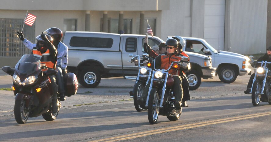 Left: Col. Anthony Cotton and his wife, Marsha, wave at the crowd while participating in the 9/11 Freedom Ride as part of the Patriot Day activities in Great Falls Sept. 11. Riding with the 341st Missile Wing commander is Col. Peter Hronek, 120th Fighter Wing commander, and his wife, Traci. (U.S. Air Force photo/Staff Sgt. Mike Touchette)