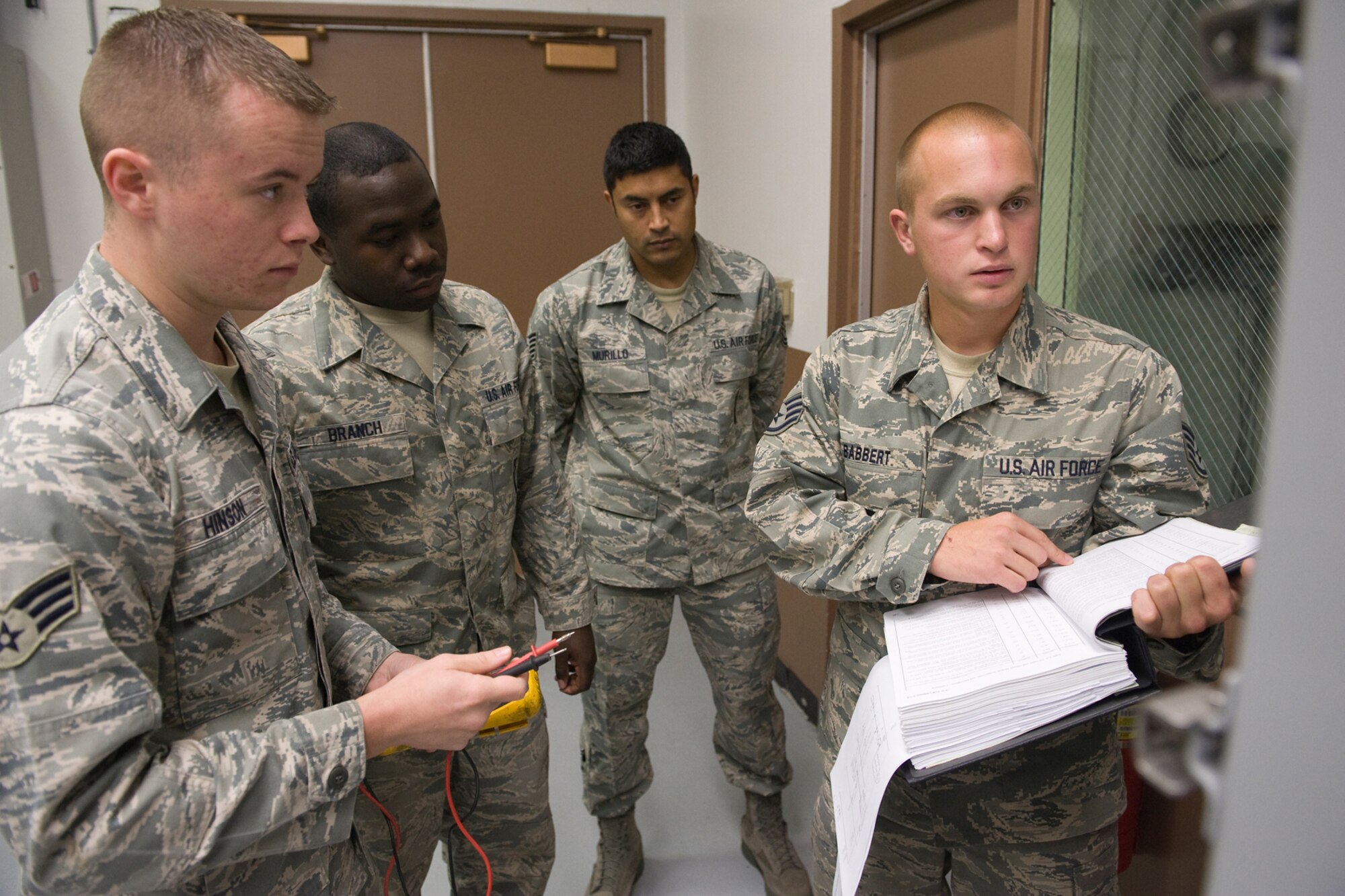 Global Strike Challenge Facilities Maintenance Team trainer Tech. Sgt. Jorge Murillo, rear, listens and watches as his team evaluates the best way to proceed during training for the upcoming competition. Team members, left to right, are Senior Airman Andrew Hinson, Senior Airman Jonathon Branch and Staff Sgt. Kyle Babbert. (U.S. Air Force photo/Beau Wade)