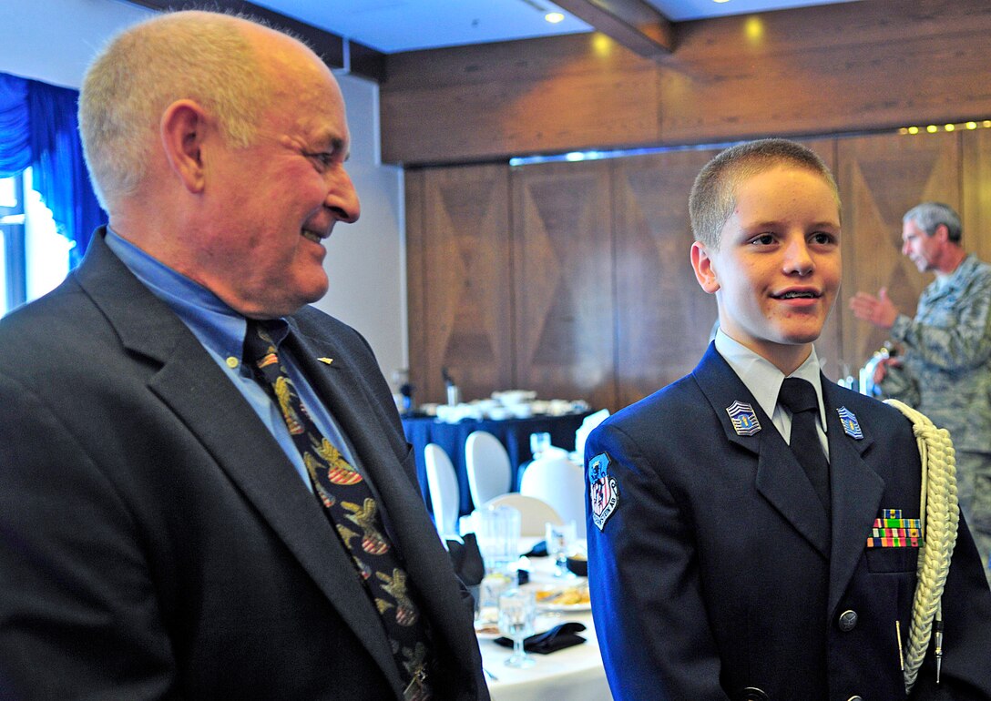 Former prisoner of war, retired Navy Capt. David Hoffman and Christian Britton talk with other servicemembers during the POW/missing in action luncheon Sept. 17, 2010, at Ramstein Air Base, Germany. Christian is Junior ROTC cadet and son of Senior Master Sgt. Vince Britton, 435th Contingency Response Group superintendent of contingency operations. (U.S. Air Force photo/Senior Airman Amanda Dick)
