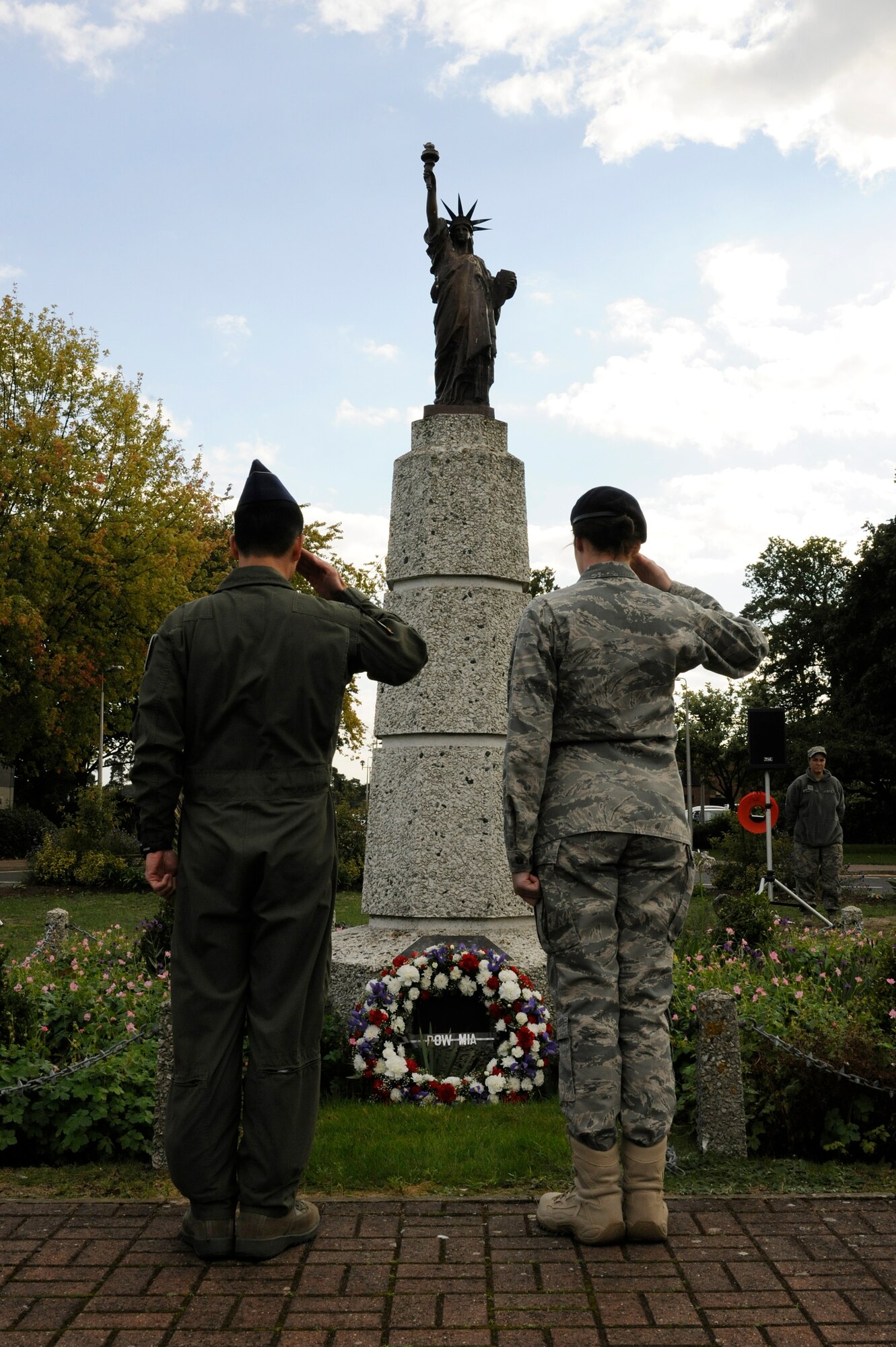 ROYAL AIR FORCE LAKENHEATH, England – Col. John Quintas, 48th Fighter Wing commander, and Airman Basic Shelby Custer, 48th Security Forces Squadron patrolman, salute after presenting a wreath in honor of prisoners of war and missing in action during the POW/MIA retreat ceremony Sept. 17, 2010. (U.S. Air Force photo/Airman 1st Class Lausanne Morgan)