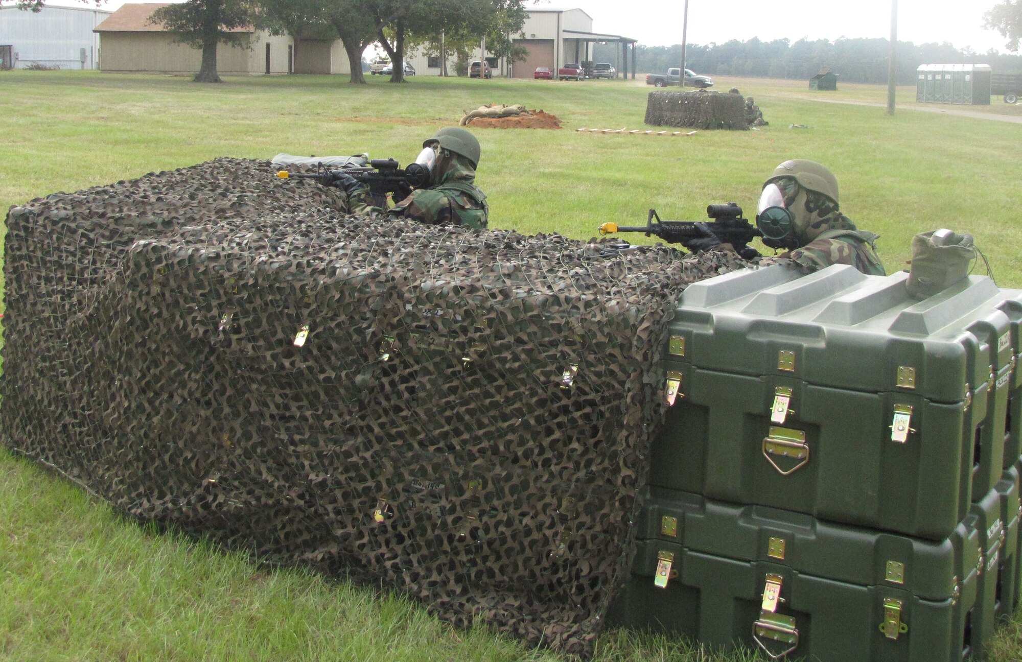 Two Members of the 560th RED HORSE Squadron guard the entry control point while in MOPP 4 during their annual field training exercise Sept. 10-13, 2010 at North Auxiliary Air Field (U.S. Air Force photo/Tech. Sgt. Steve Wells)