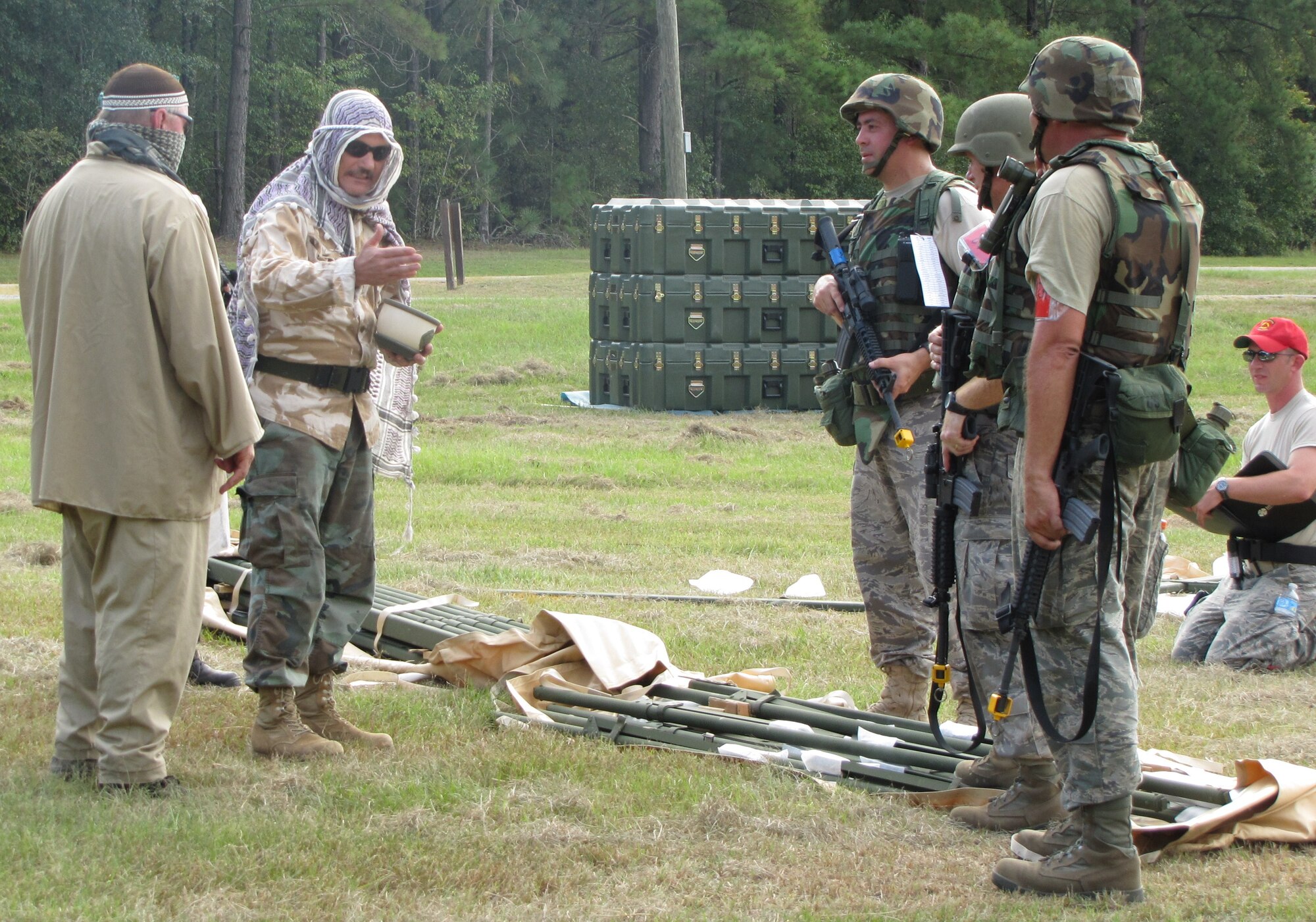 Chief Master Sgt. Jim Hampton and two other members of the 560th RED HORSE Squadron speak with South Carolina State Guardsmen dressed up as Pashtun tribesmen in an exercise scenario during their annual field training exercise Sept. 10-13, 2010 at North Auxiliary Air Field S.C. (U.S. Air Force photo/Tech. Sgt. Steve Wells)