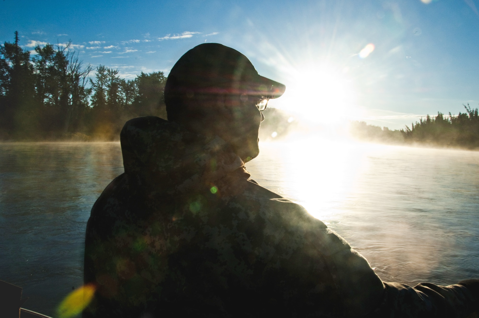 Petty Officer 1st Class Emilio Rodriguez takes in the scenery during a chartered fishing trip Sept. 11, 2010, on the Kenai River, Alaska as a part of Project Healing Waters. (U.S. Air Force photo/Airman 1st Class Jack Sanders)