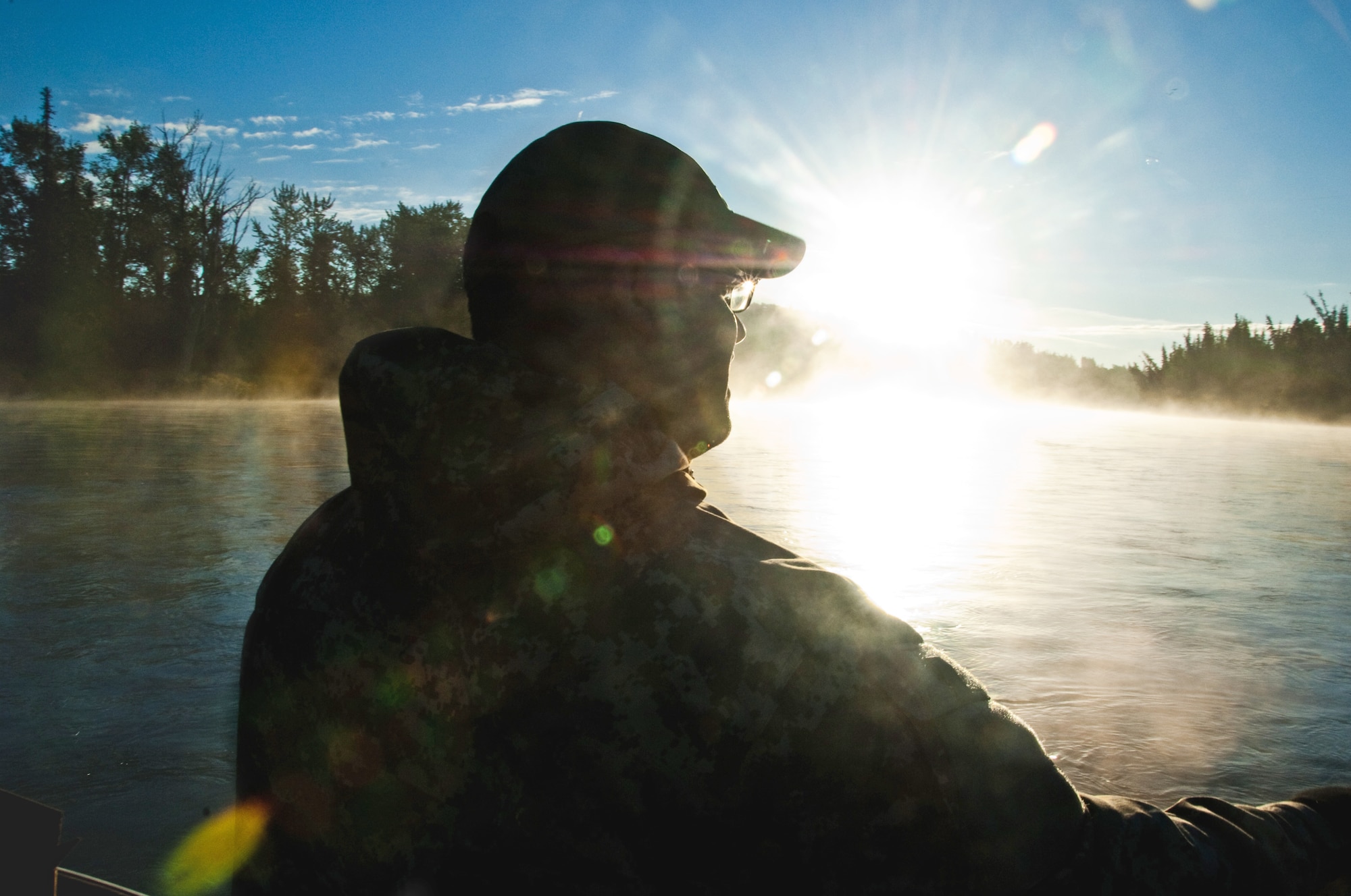 Petty Officer 1st Class Emilio Rodriguez takes in the scenery during a chartered fishing trip Sept. 11, 2010, on the Kenai River, Alaska as a part of Project Healing Waters. (U.S. Air Force photo/Airman 1st Class Jack Sanders)