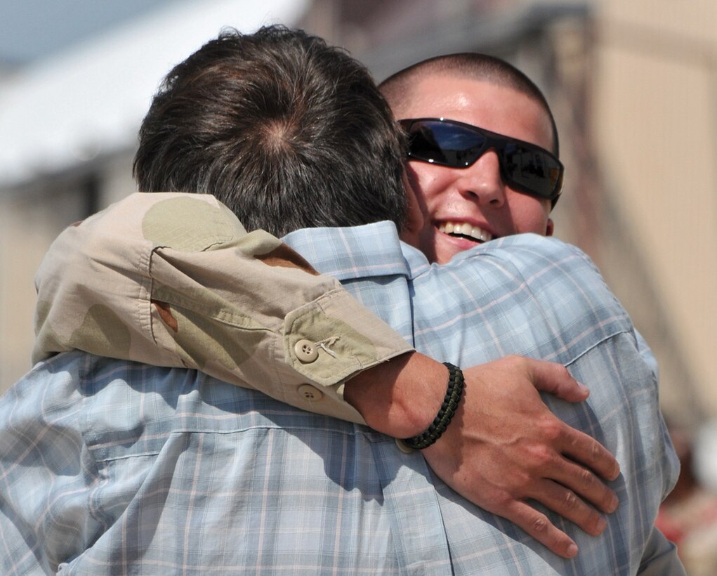Aircrew Survival Equipmentman Third Class William Rahrig, assigned to Electronic Attack Squadron VAQ-209, receives a hug from his father. (Photo by MC2 (AW) (SW) Clifford L. Davis)