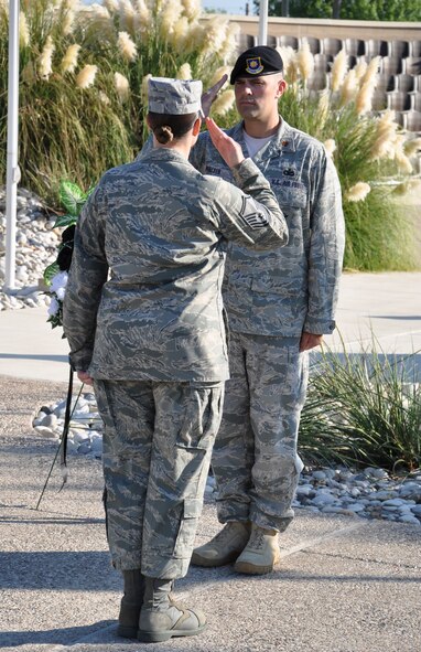 LAUGHLIN AIR FORCE BASE, Texas – Maj. Ian Dinesen, 47th Security Forces Squadron commander, passes his duties of standing guard over a POW/MIA remembrance wreath to Master Sgt. Laurie Freeman, 85th Flying Training Squadron, at Laughlin’s Heritage Park Sept. 17. The vigil was part of Laughlin’s POW/MIA Recognition Day activities, which also included a roundtable discussion with a former prisoner of war and three other Vietnam veterans who were shot down in action as well as a retreat ceremony. (U.S. Air Force photo by Airman 1st Class Blake Mize)