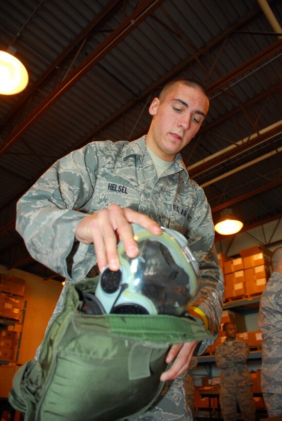 Airman Basic Shaun Hesel, 914th Civil Engineering Squadron operations management, inspects chemical training gear during an exercise September 11, 2010.  Airman Hesel performs inspections on required gear to make sure everything is operational.  All gear and deployment folders are inspected to ensure Airmen are ready to deploy at a moment’s notice.    (U.S. Air Force Photo by Senior Airman Jessica Snow)