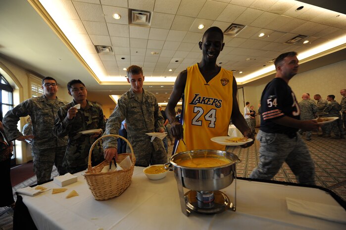 Airman 1st Class Jamel McCargo prepares a plate of nachos at the 628th Mission Support Group appreciation luncheon. The MSG luncheon was held to thank the members of Team Charleston for their support throughout the past year. The event was sports-themed and members were encouraged to show their team spirit by donning their favorite team's jersey. Airman McCargo is a radio frequency transmission technician with the 628th Communications Squadron. (U.S. Air Force Photo/Airman 1st Class Lauren Main)