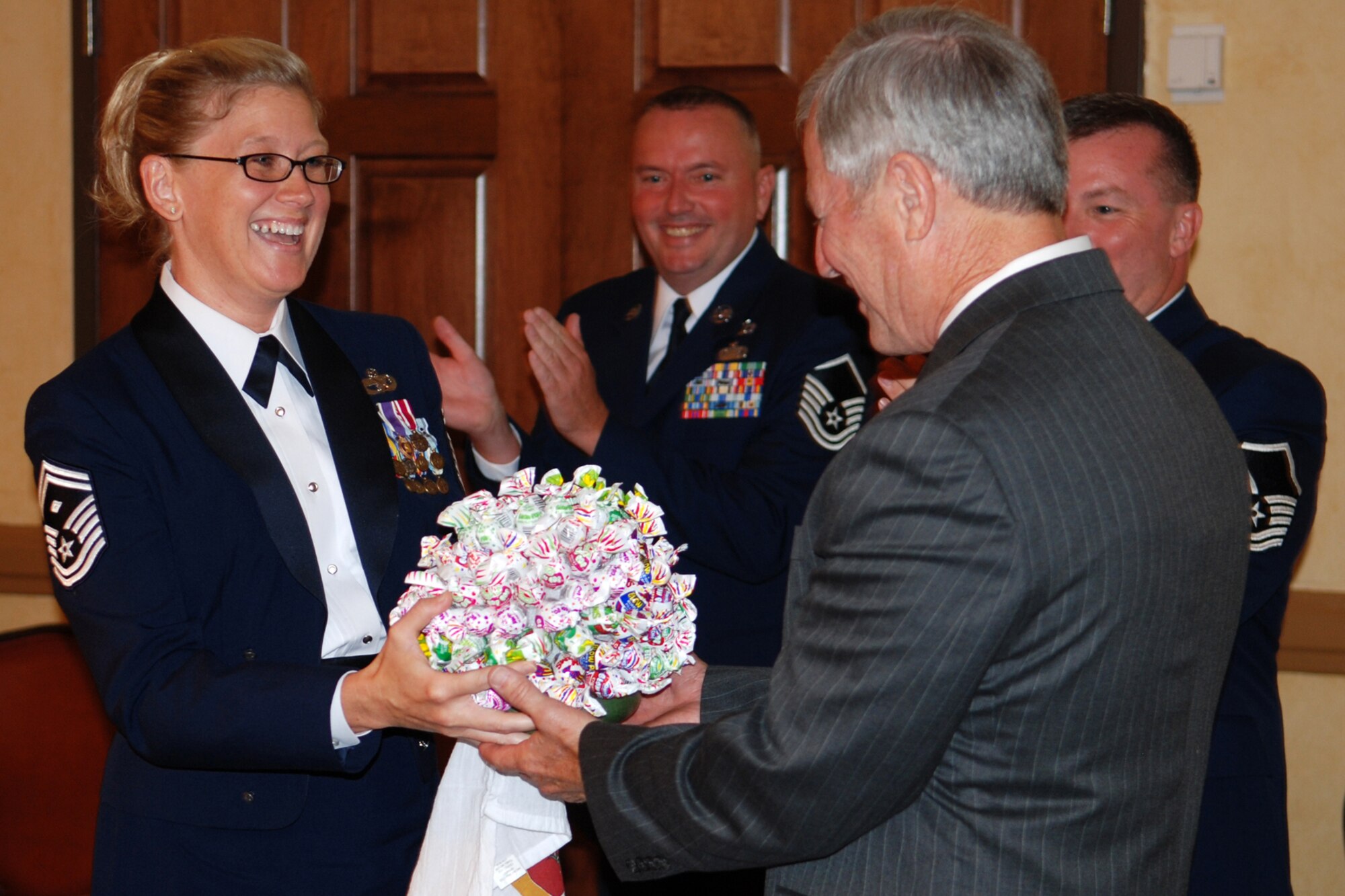 Master Sgt. Shelly R. Cohen, first sergeant, 307th Red Horse Squadron, presents Chief Master Sgt. (Ret) Jack Skaggs a bouquet of candy lollipops at the 917th Wing’s 7th Annual Senior Noncommissioned Officer Induction and Chief’s Recognition Ceremony at the Barksdale Club on Barksdale Air Force Base, La., Sept. 11, 2010. Chief Skaggs, who is a former Command Chief Master Sergeant of the 917th Wing, is famous for the box of lollipops he carried under his arm as he visited with Airmen assigned to the 917th wing both here and abroad. (U.S. Air Force photo/Master Sgt. Greg Steele)