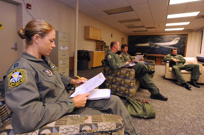Capt. Jamie Turner looks at her Flying Training Accomplishment Report (a ground and flying checklist) during a crew brief  prior to a routine flying training mission from Joint Base Charleston, S.C., Sept. 15, 2010. Capt. Turner was selected as one of 1,800 Iroman World Championship competitors. She will test her physical and mental endurance against one of the biggest challenges the sports world has to offer. Captain Turner will swim 2.4-miles through ocean waves, bike 112-miles and run a 26.2-mile marathon through challenging lava-covered terrain. Captain Turner is a pilot with the 315th Airlift Wing. (US Air Force photo/James M. Bowman)