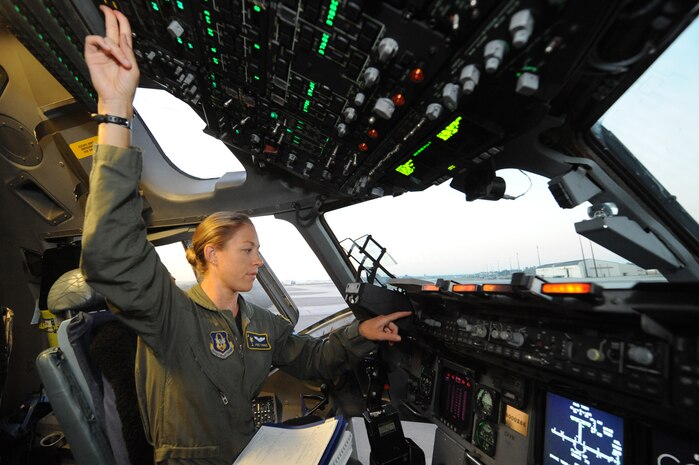 Capt. Jamie Turner performs a pre-flight inspection on a C-17 prior to a routine flying training mission from Joint Base Charleston, S.C., Sept. 15, 2010. Captain Turner was selected as one of 1,800 Iroman World Championship competitors. She will test her physical and mental endurance against one of the biggest challenges the sports world has to offer. Captain Turner will swim 2.4-miles through ocean waves, bike 112-miles and run a 26.2-mile marathon through challenging lava-covered terrain. Captain Turner is a pilot with the 315th Airlift Wing. (US Air Force photo/James M. Bowman)