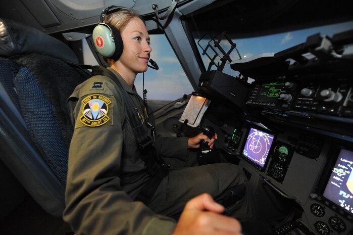 U.S. Air Force Capt. Jamie Turner performs quarterly continuation training on a C-17 flight simulator while at Joint Base Charleston, S.C., Sept. 7, 2010. While in the simulator she will practice emergency training, routine flying and instrument procedures. Captain Turner was selected to attend the Ironman World Championship at Kona, Hawaii. Capt. Turner was selected as one of 1,800 Iroman World Championship competitors. She will test her physical and mental endurance against one of the biggest challenges the sports world has to offer. Captain Turner will swim 2.4-miles through ocean waves, bike 112-miles and run a 26.2-mile marathon through challenging lava-covered terrain. Captain Turner is a pilot with the 315th Airlift Wing. (US Air Force photo/James M. Bowman)

