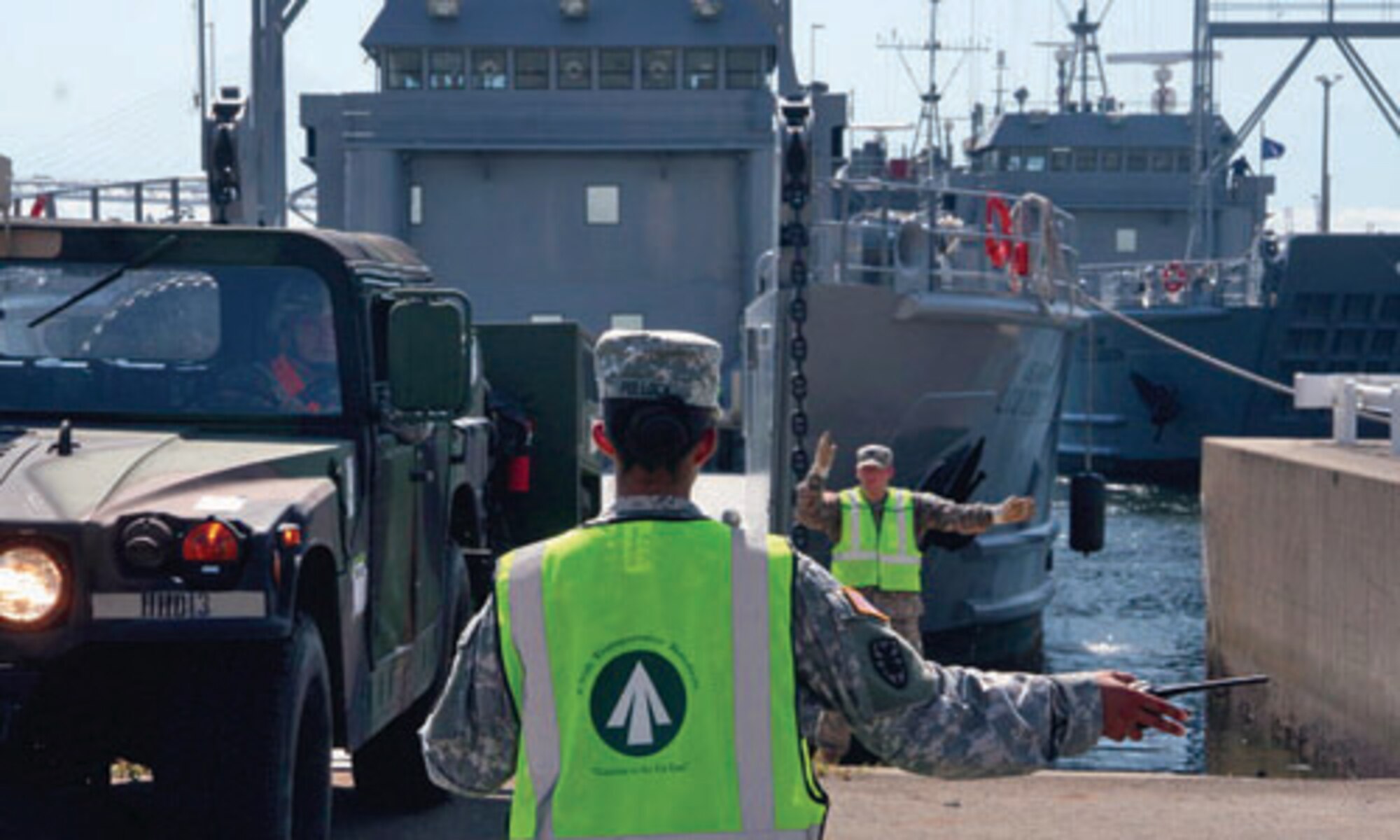 Sgt. Melissa Pollock, 97th Transportation Company, 10th Transportation  Battalion, 7th Sustainment Brigade, guides a Humvee onto the deck of an Army vessel in preparation for Pacific Reach 2010 at Yokohama North Dock, Japan. (Photo by Sgt. 1st Class Sean Riley, Army Sustainment Command Public Affairs Office) 
