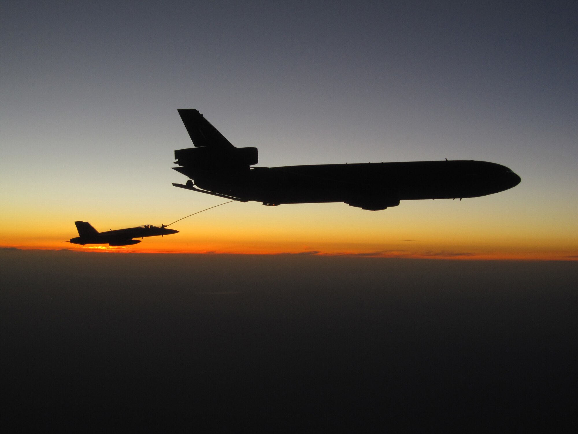 An F/A-18E Super Hornet fighter assigned to Strike Fighter Squadron (VFA) 143 refuels from an Air Force KC-10 Extender tanker aircraft assigned to the 379th Expeditionary Wing May 2, 2010, over Afghanistan. (U.S. Navy photo by Lt. Cmdr. Ben Stickney)