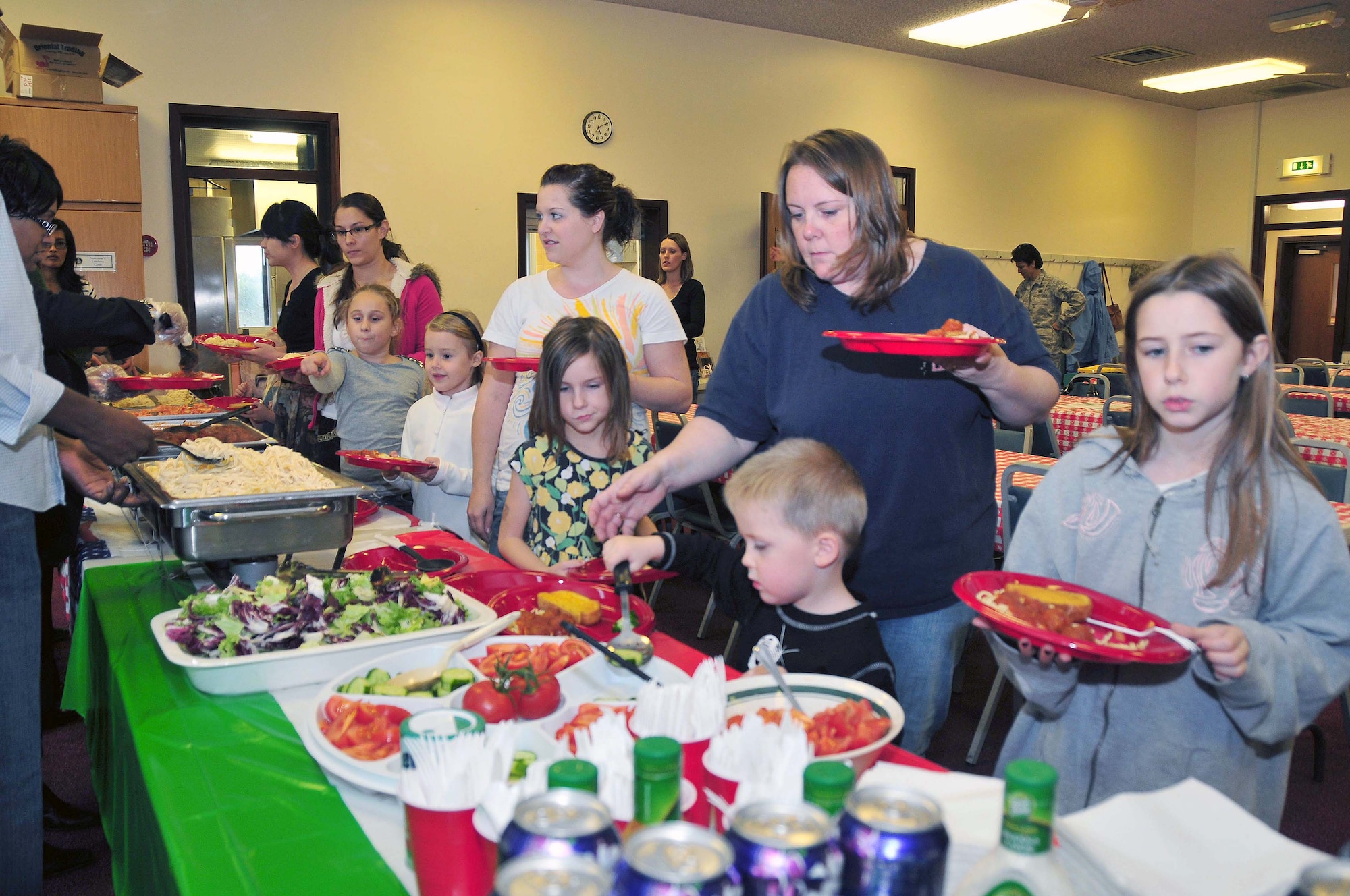ROYAL AIR FORCE LAKENHEATH, England -- Family members make their way through the buffet line at the Deployed Families Dinner on Sept. 16, 2010. The base hosts this special dinner for the spouses and children quarterly to show support and let the families know they’re not forgotten while their loved ones are deployed. (U.S. Air Force photo/Staff Sergeant Conner Estes)