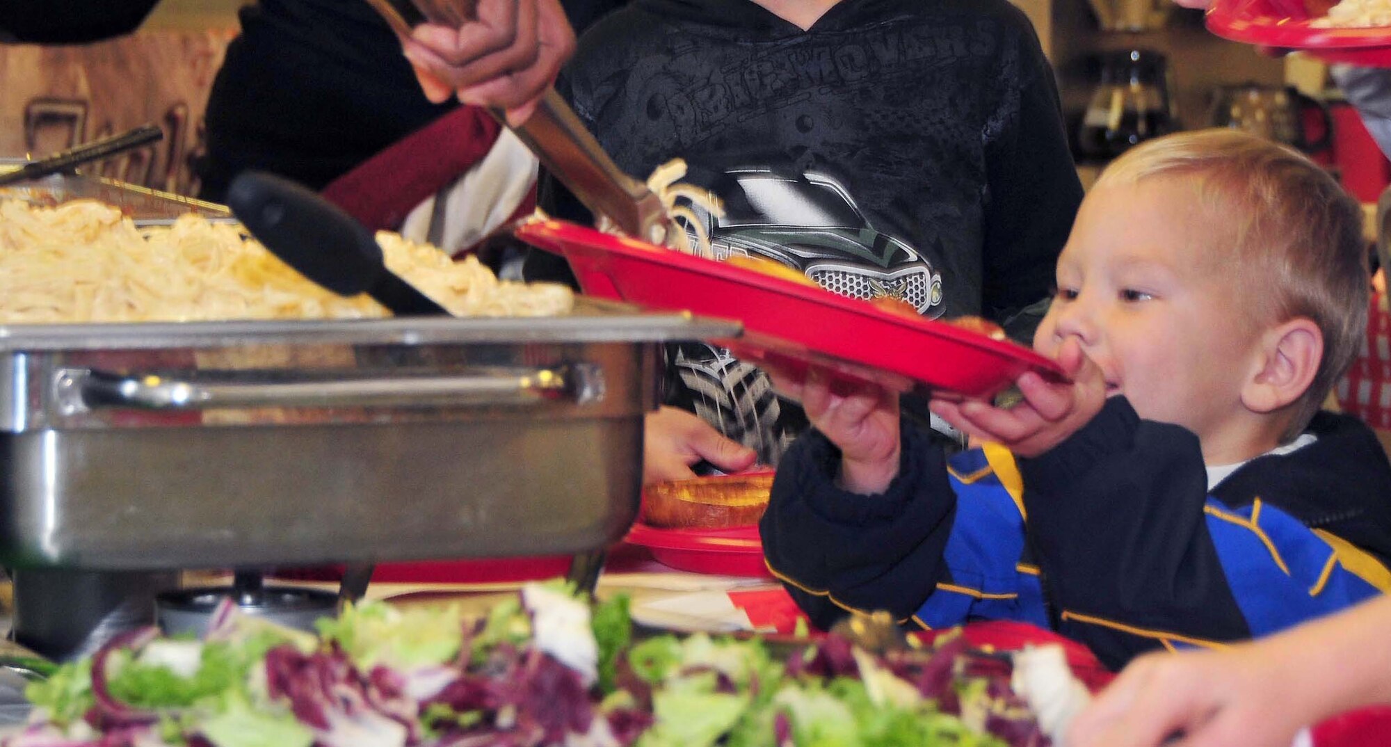 ROYAL AIR FORCE LAKENHEATH, England – Kaell Berry, son of Master Sgt. Jason Berry, 48th Civil Engineer Squadron Fire Department assistant chief of operations (currently deployed), is served food during the Deployed Families Dinner on Sept. 16, 2010. The dinner is held each quarter for families with deployed members. (U.S. Air Force photo/Staff Sergeant Conner Estes)