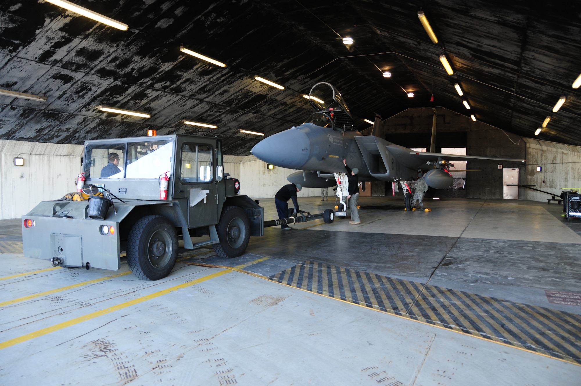 KEFLAVIK, Iceland – Airmen work together to situate an F-15C Eagle inside a hangar Sept. 16, 2010. F-15C and F-15D aircraft have been deployed to Iceland from RAF Lakenheath, England as a part of NATO’s Icelandic Air Policing mission. (U.S. Air Force photo/Senior Airman Stephen Linch)