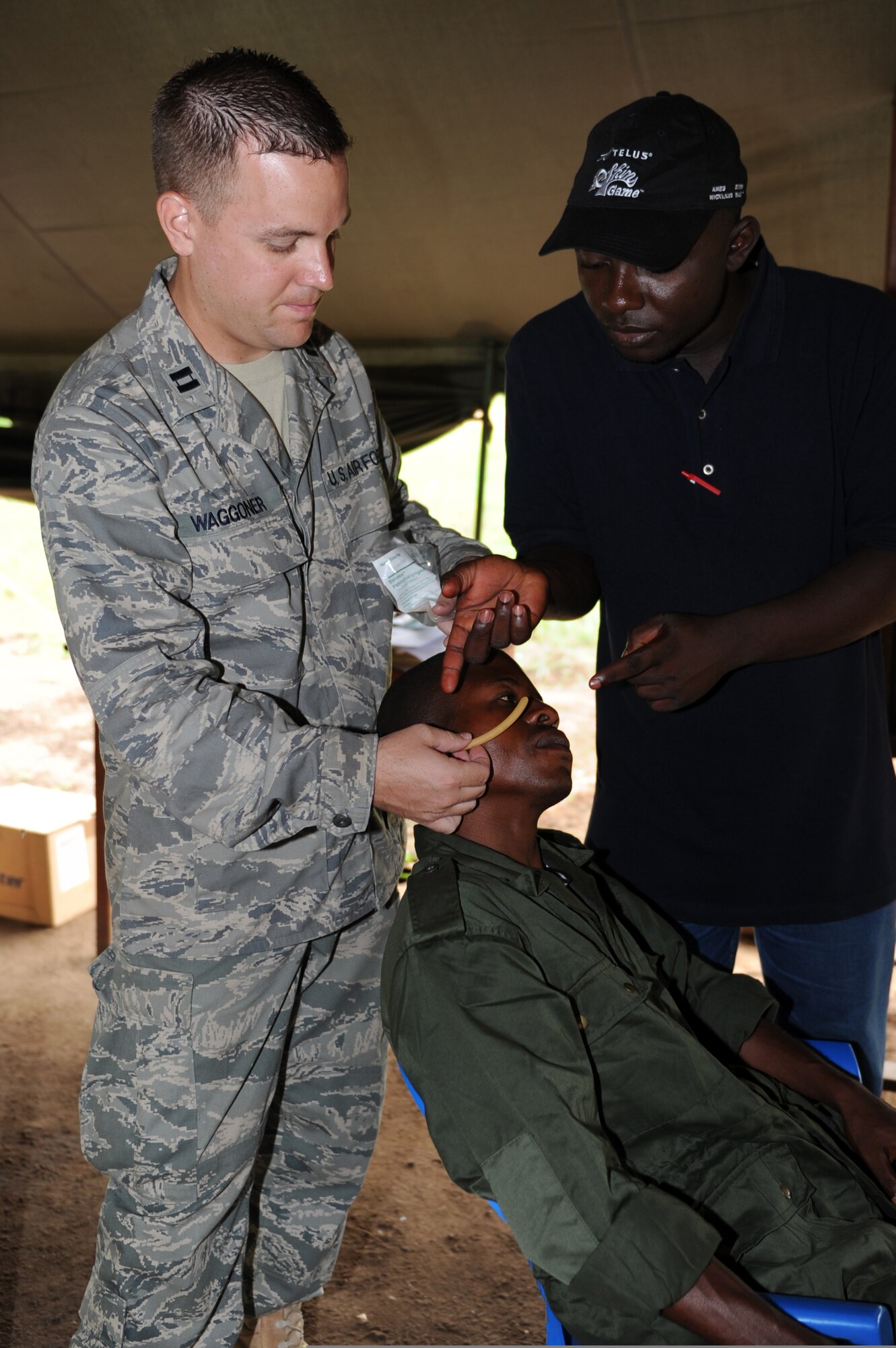 KISINGANDI, Democratic Republic of the Congo - Capt. Adam Waggoner (left) performs hands-on training with Congolese medics while providing medical support to a 30-person Special Operations Command and Control Element working to train a Light Infantry Battalion of DRC soldiers on Sept. 10. Captain Waggoner is an emergency medicine physician assistant from the 96th Medical Group at Eglin Air Force Base, Fla. (U.S. Air Force photo)