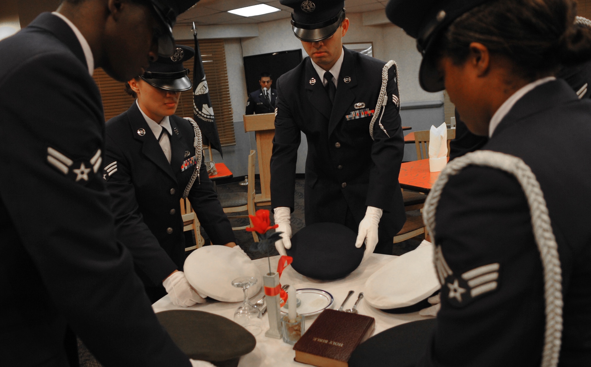 Honor guard members set the POW/MIA remembrance table at the Ginko Dining
Facility Sept. 16. National POW/MIA Recognition Day is annually observed in
the United States on the third Friday of September. The base held
observances and ceremonies for the entire week leading up to the national
observance. (U.S. Air Force Photo/Senior Airman Evelyn Chavez)
