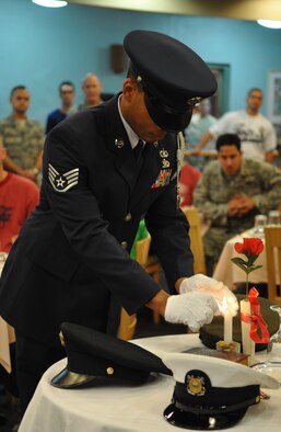 An honor guard member lights a candle at the POW/MIA remembrance table at
the Ginko Dining Facility Sept. 16. National POW/MIA Recognition Day is
annually observed in the United States on the third Friday of September. The
base held observances and ceremonies for the entire week leading up to the
national observance. (U.S. Air Force Photo/Senior Airman Evelyn Chavez)

